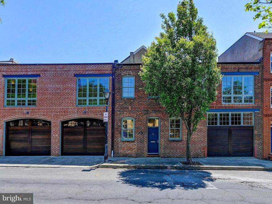 Welcome to 21 W Hughes, perfectly situated where Federal Hill meets Otterbein. Incredibly large, "triple wide" (over 5,000 square feet) loft-style home with an oversize 2-car garage & a private courtyard. Designed by local architect Rebecca Swanston, this classic contemporary home centers around a massive double-sided stone fireplace. The open main level offers a huge dining room space; a deluxe gourmet kitchen with high-end stainless steel appliances and a large wine refrigerator.  Two separate living areas overlook a spectacular outdoor oasis! There is also a main floor bedroom and full bath. Upstairs you will find the spacious primary suite with a courtyard view, a large walk-in closet, and a spa bath. This floor also offers 2 additional large bedrooms, 1 with an en suite, and a grand family room. An additional hall bath and convenient laundry room round out this floor. Truly a one of a kind custom home that you won't want to miss.