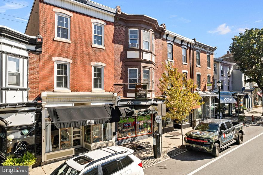 Located along the premier stretch of Manayunk’s Main Street corridor, this well-maintained three-unit mixed-use property offers an exceptional balance of stable income, long-term tenancy, and timeless architectural character. Surrounded by the neighborhood’s most desirable retail, dining, and pedestrian activity, the property enjoys excellent visibility and enduring appeal in one of Philadelphia’s most vibrant commercial districts.

The building consists of three units: a first-floor commercial space, a second-floor two-bedroom, one-bath apartment, and a third-floor studio apartment that lives comfortably like a one-bedroom. The commercial suite is occupied by an established tenant under a long-term lease extending through 2030, providing reliable, predictable income and benefiting from steady foot traffic and strong street presence. The two residential units are leased on annual terms to dependable tenants, each offering well-proportioned layouts, abundant natural light, and a proven record of consistent occupancy with strong rent performance.

The property has been carefully maintained and recently upgraded with a new fire alarm system and backflow prevention, ensuring compliance with modern safety and utility standards. These improvements, combined with ongoing upkeep, reflect the pride of ownership and long-term investment quality of the asset.

With its mix of stable commercial tenancy, desirable residential units, and prime location within Manayunk’s historic corridor, this property presents a rare opportunity to acquire a turnkey, income-producing investment with lasting appeal and strong fundamentals in one of Philadelphia’s most enduring submarkets.