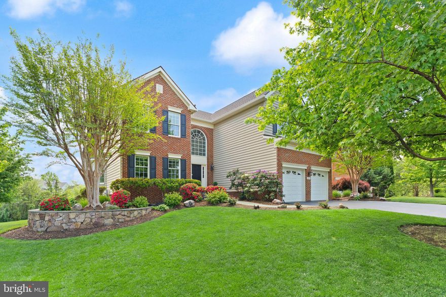 Positioned at the end of a cul-de-sac within the prestigious Belmont Country Club community, this original owner residence offers a rare combination of privacy, amenities, and prime golf course frontage. Backing directly to the 7th hole and bordered by an expansive side common area, the property feels uniquely open with only one immediate neighbor, setting the stage for a refined living experience. Past the beautifully manicured landscaping and two-stall garage, the front entry opens to a dramatic two-story foyer filled with natural sunlight. The main level offers a light and airy living and dining space, where a bay window and wainscoting, and rich wide-plank hardwood flooring add a touch of traditional elegance. The heart of the home is the open-concept family room, featuring soaring vaulted ceilings, a brick fireplace, and massive Palladian windows that frame the golf course views. This space flows seamlessly into the eat-in kitchen, which includes a center island, granite countertops, and abundant storage. A private home office, upgraded  laundry room, and powder bath complete the main floor. Upstairs, a landing offers flexible space suitable for a reading nook before leading to four of the home’s five bedrooms. The luxe primary suite serves as a private escape with vaulted cathedral ceilings and fan, a sitting area retreat, and a large walk-in closet. The redesigned primary bathroom includes a double-sink vanity, beautiful maple cabinetry and frameless shower. A second upper-level bedroom is a suite with its own private bath, while the remaining two upstairs bedrooms share a full hall bath. The custom finished lower level extends the home’s living space significantly, featuring a spacious recreation room with a built-in bar, kitchen and full-size windows for natural light. This floor also hosts the fifth legal bedroom, a full bathroom, a laundry room, and a bonus room, with a convenient walkout directly to the yard. The exterior spaces are designed to maximize the location surrounded by professional landscaping, irrigation system and invisible fencing. The living areas open directly to a spacious back deck, creating a perfect indoor-outdoor flow for relaxing, grilling, and dining under the stars against a backdrop of trees and fairways.  Over 100K in updates and replacements: Roof (2020), 2 AC’s replaced- main level (2020), Insulated garage doors with custom shelving (2020), 2 New sets of washers and dryers (within 5 years), Attic Fans (2020), Water Heater (2018), New Gutters (2020), LL Appliance package (2020). Residents of the Belmont community enjoy an extensive array of amenities, including the Arnold Palmer-designed 18-hole golf course, a 35,000 square foot clubhouse, and the Historic Belmont Manor Home. The community offers dining venues, social events, multiple pools, tennis, basketball and volleyball courts, playgrounds, and a fitness center with dedicated workout studios. For convenience, high-speed internet, cable TV, and full lawn and landscape maintenance are included. Located minutes from major shopping centers, dining options, highly rated schools and commuter routes, this property offers effortless access to all the best amenities Northern Virginia has to offer.