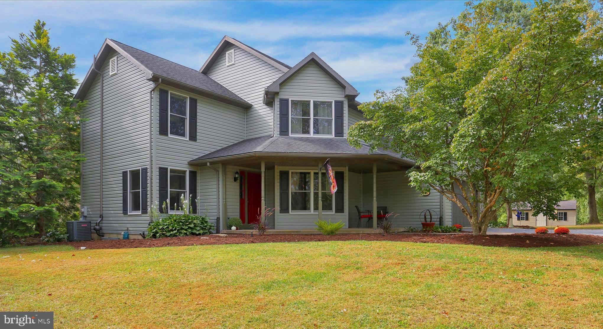 This charming home offers a perfect blend of comfort and functionality. With 4 spacious bedrooms and 2.5 bathrooms, the layout is designed for both relaxation and entertaining. The inviting living area features a cozy wood-burning fireplace, perfect for those chilly evenings, while the hardwood and ceramic tile flooring add a touch of elegance throughout. The heart of the home is the well-appointed kitchen featuring 28 handle cherry cabinetry, is equipped with essential newer appliances including an electric oven/range, refrigerator, and convenient main floor laundry. The primary bath was remodeled in 2020 and boasts a tiled stall shower, ensuring a private retreat. Ceiling fans throughout enhance the airy feel, making every room a delightful space to unwind. Step outside to your personal oasis on over an acre of land, where you can enjoy the above-ground pool and expansive decks, ideal for summer gatherings. The property features a level yard with beautiful views of trees and pasture, providing a peaceful backdrop for outdoor activities. Located in a rural setting, this home is just a short drive from major roadways, local parks, schools, and community amenities, fostering a sense of belonging. With an attached garage and ample parking, convenience is at your fingertips. Roof was replaced in 2014, Vinyl Siding was replaced in 2023.The furnace was replaced in 2021 and the A/C was replaced in 2020. The deck was redone in 2006, the pool was added in 2018 and the well pump was replaced in 2021. Experience the warmth and charm of this delightful property, where every detail invites you to create lasting memories. There is a recorded easement to the right on the property that leads to the parcel behind.