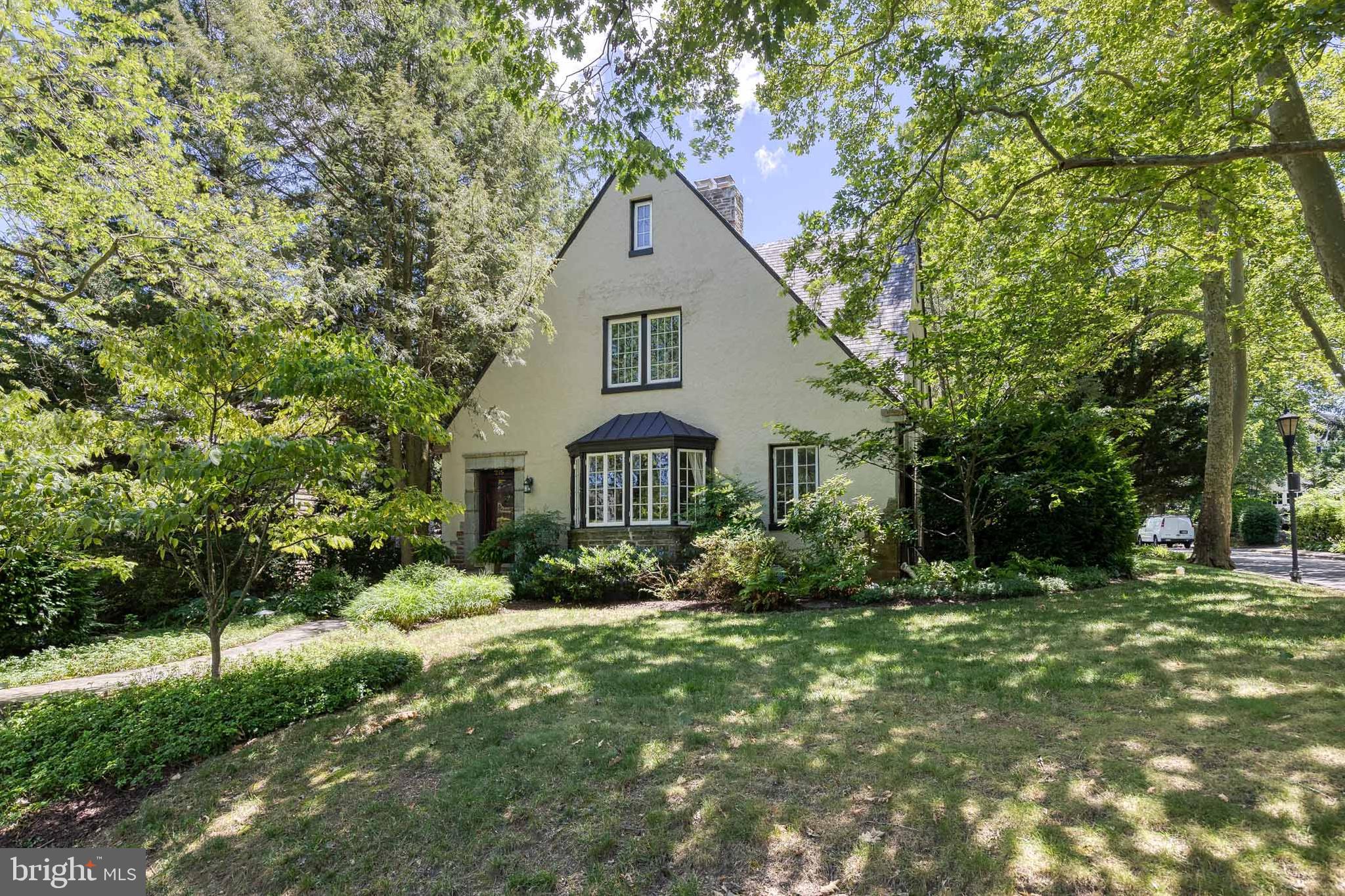 Exceptional Properties. Exceptional Clients. Welcome to 215 Saint Dunstans, a spacious and charming 4 bedroom, 3 full 2 half bath classic Tudor style stucco home with a private driveway and detached 2 car garage located on a large corner lot in sought-after historic Homeland. Situated on the Homeland Lakes, these lucky homeowners will get to enjoy the beautiful cherry trees, feed the ducks and fish and listen to the fountains. The elegant property features classic architectural details, modern upgrades, a versatile floor plan and tons of space, including a finished basement and home gym. Through the welcoming foyer, you’ll find a grand living room with a wood burning stone fireplace, formal dining room, and a gourmet kitchen with stainless steel appliances, island, and floor to ceiling cabinets, all thoughtfully designed for cooking and entertaining, with a door leading out to the large flagstone patio and flat, grassy backyard. Off the dining room, step into a bright and welcoming sunroom that spills out to the deck and mature gardens. Climb the stairs to discover three generous sized bedrooms and a bonus room plus two full baths, including an en-suite to the primary bedroom. On the third floor, you’ll find the fourth bedroom and third full bath. The newly finished basement features a grand entertainment center, bathroom, home gym, and an updated laundry room featuring plenty of pantry space and extra storage. The tasteful property features wood floors, crown molding and high ceilings. The sizable detached garage features automatic door openers, room for two cars, a workshop space, and tons of storage room, plus additional parking on the driveway for several cars. A picket fence surrounds the property, with hardscaped paths leading to the tree-lined front yard. This location cannot be beat sitting on the Homeland Lakes - with great access to commuting routes, nearby shopping, all the best the city has to offer but also close to Towson; this property offers suburban charm against a city backdrop. A rare opportunity to be in Homeland, this property is an estate sale and is being sold as-is.