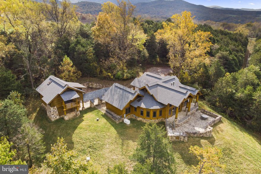 Nestled in the heart of Virginia's Shenandoah Valley stands Hamatreya, a bespoke masterpiece with unparalleled mountain vistas. This award-winning contemporary retreat, inspired by Ralph Waldo Emerson's poem "Hamatreya," redefines luxury living on almost 10 acres overlooking majestic Massanutten Mountain and the lush George Washington National Forest.

An Eco-Friendly Oasis of Modern Luxury

-As seen in three distinguished magazines, Hamatreya offers a blend of sustainable design and modern comfort. This energy-efficient haven features a main house with three distinctive bedrooms, each with en-suite bathrooms designed to emulate individual cabins, plus a carriage house complete with a studio apartment loft above a 2-car garage.

Indoor and Outdoor Elegance

-Experience breathtaking sunrises and sunsets year-round, whether through expansive windows or on the extensive stone terrace. Enjoy outdoor living at its finest with a built-in wood-burning fireplace and an outdoor kitchen.

Organic Connection to Nature

-Hamatreya's curvilinear design creates a seamless blend between indoor and outdoor spaces. A well-proportioned and defined great room, kitchen, and dining area add charm and functionality, accented by handcrafted pottery, custom lighting fixtures, and a grand stone fireplace clad in copper.

Master Craftsmanship in Every Detail

-Each bedroom with a private en-suite bathroom offers access to an open central great room and a captivating stone terrace. Custom cabinetry crafted by renowned artisans adds to the allure, as do luxurious bathrooms adorned with log and glass canopies and superior Grohe fixtures.

High Speed Internet Allows Business to Be Run from Property

-Property has Starlink Internet with speeds that effortlessly handle anything, with large throughput. specs:
 -DOWN: 117 Mbps
-UP: 8.81 Mbps
-VID: 2160p max resolution, 2014 ms, 0% buffering

Site Details

-Private, secluded property located directly off county-maintained US 340  but not visible from the highway
69 Miles from Dulles International Airport, 13 Miles from Luray Caverns Airport (KLUA), 14 miles from the Front Royal-Warren County Airport (FRR)

Build Your Dream on a Second Lot

-This offering includes a second 5-acre lot, perc-tested and primed for future development. Explore the possibilities and make Hamatreya your personal paradise today.


Green Systems/Items Include: 

Natural timber
Geothermal and radiant heat
Strategically placed solar panels
Locally sourced stone
Conservation-minded/recycled materials
Tankless -water heater
Generator
800 feet deep artesian well

Although the tax assessment lists the property as having 3, 165 square feet of above grade finished, space, based on the floor plans, the listing agent has computed approximately 3,550 above grade finished square feet for the main house and approximately 345 above grade finished square feet in the carriage house for a total of about 4,443 finished above grade square feet. Additionally, the below grade mechanical room is approximately 390 square feet, the garage is about 725 square feet counting the space for the cars and workbench as well as the closet.

The property is listed as having 3 bedrooms in the main house plus an efficiency apartment in the carriage house. The floor plans show the carriage house having a bedroom which would bring the total for the property to 4 bedrooms. Although there is a seperate space in the carriage house apartment for a bedroom, no doorway or door was put in...although that can be added.