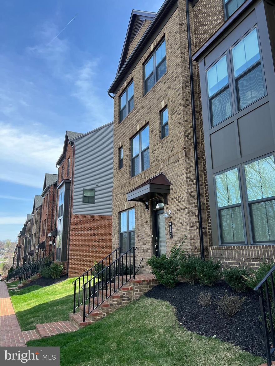 Impeccably maintained VAN DORN model.  END UNIT, two-car garage townhome in METRO ROW! Oakton High School pyramid.  This 4 bedroom/3.5 bathroom was built in 2019 and there are so many upgrades to pass on to the new homeowners! The main level entry can be accessed either through the rear entry two -car garage or the elegant brick front entry.  This main level foyer is warm and inviting with a custom alcove for shoes/storage.  This owner selected the upgraded option of the additional fourth bedroom with an attached full bathroom on the main level - perfect for guests or a home office.  

As you walk up to the second level you will love seeing the view through glass doors out to the “Sky Lanai” which is a covered balcony with plenty of room for hosting dinners or enjoying the view. The open concept upper level has a gourmet kitchen with a HUGE island  w/ seating.  The kitchen countertops are Iced White Quartz, the cabinets are Sonoma Painted Linen with contemporary pulls.  The appliance package is the upgraded GE Premier II and GE Profile and you will love the under cabinet lighting, ceramic backsplash and pendant lighting!  The flooring is a beautiful Oceanside Gray 5” Oak Engineered Plank.  The eat-in kitchen flows into the Family Room with plenty of room for entertaining.  

Upstairs features three additional bedrooms with upgraded carpeting and Extreme Comfort padding.  The primary bedroom has a large walk-in closet and an en suite bathroom with upgraded Crema Marfil Quartz countertops and Scottsdale Maple Espresso Cabinets, a private water closet and a custom-tiled shower. The washer and dryer are also upstairs for a great added convenience! 

MINUTES to Vienna Metro and Bus Stop.  Walking distance to shopping center and short drive to Mosaic District. Quick access to Rt 29, Rt 50, I-66 and I-495. Minutes to the Gerry Connolly trail that connects to the W&OD trail.