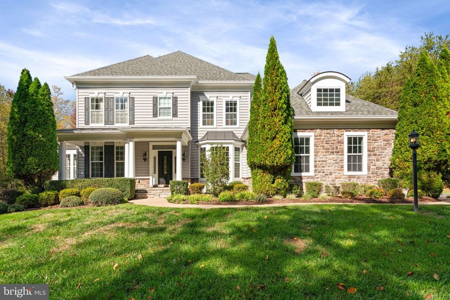 Set on 3.45 private acres in The Glens, one of Stafford’s most sought-after estate communities, this custom stone-and-brick Colonial blends timeless architecture with modern comfort across more than 7,000 finished square feet. Designed for those who appreciate fine craftsmanship, thoughtful design, and outdoor living at its best, every element of this residence speaks to refined quality.

A welcoming covered front porch leads into a grand interior with hardwood floors, crown molding, and architectural detail throughout. The main level offers elegant formal spaces, including a living room with bay windows, a formal dining room with chair rail and crown molding, and a private study ideal for work or quiet reflection. The gourmet kitchen is the centerpiece of the home, featuring granite countertops, slow-close maple cabinetry to the ceiling, double wall ovens, gas cooktop, stainless-steel appliances, butler’s pantry, tile backsplash, and a large island with seating. The sunroom opens directly to the composite deck, creating an easy indoor-outdoor flow.

The family room showcases a stone gas fireplace rising to the ceiling, coffered ceiling, and crown molding, offering an inviting space for gathering. Upstairs, the primary suite provides a tranquil retreat with a tray ceiling, sitting area, and two walk-in closets. The luxury bath includes dual vanities, a soaking tub, and a Roman shower with dual shower heads and tiled archway. Three additional bedrooms include one ensuite and a Jack-and-Jill configuration, all with generous closets.

The fully finished walk-out lower level extends the home’s versatility with a recreation room, media room with built-in stereo, exercise area, and a custom wet bar/kitchenette featuring granite counters, backsplash, dishwasher, and refrigerator. A full bath and open layout make this level ideal for entertaining or long-term guests.

Outdoors, experience your own private resort style oasis with a screened and covered patio, deck and in-ground pool with waterfall edge and hot tub, all surrounded by vinyl fencing, irrigation system, and mature landscaping. 

Located just minutes from I-95, shopping, and dining, this remarkable property offers the best of luxury country living in The Glens—where privacy, craftsmanship, and comfort come together seamlessly.