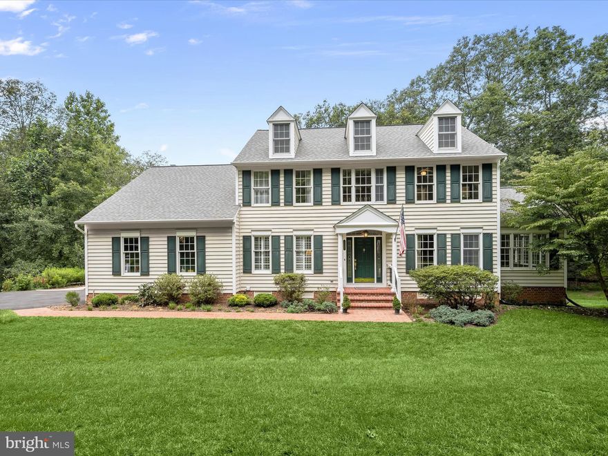 Nestled on a very private, tranquil 3.19 acre lot, at the end of a cul-de-sac, backing to  a stream/Creek, surrounded by dense trees, offering unmatched privacy and serenity in the highly sought-after subdivision of Wellington in Glenwood. This magnificent property offers the perfect blend of luxury and privacy, boasting five spacious bedrooms and four full baths, along with one half bath. With over 3,800  finished square feet on three levels, this home provides sophisticated, refined luxury with ample space for comfortable living.
Inside, the main level features brilliant, recently resurfaced hardwood floors, that flow through the welcoming living spaces, contiguous throughout the main level.
Features a magnificent sunroom encased by oversized windows to take full advantage of the wildlife that comes to drink from the creek, including deer and red fox, truly a nature lover's dream.
A fully updated gourmet kitchen, that would be the envy of any chef, is the heart of the home. Granite countertops, stainless steel appliances, a convection wall oven and microwave, 5 burner cooktop, large center island with built in shelving, make this kitchen both functional and stylish. Accessible through the kitchen, is a large trex and vinyl deck, to enjoy the lush scenic vistas, and creek/stream.                                                                                                                                     An adjacent breakfast nook provides a cozy spot for casual meals, while a sunken family room with a brick wood-burning fireplace offers a warm and inviting space to relax or entertain family or guests. For those who need work-from-home options, this home offers a secluded front office with beautiful hardwood floors. It's the perfect space to stay productive and focused, all while enjoying the comfort of home. A separate formal dining room which can easily accommodate 15 people and an updated powder room bath round out the main level. As you ascend the staircase, you'll be greeted by four very generous-sized bedrooms, including the primary owner's suite, which boasts brand new hardwood flooring. This luxurious suite features a colossal walk-in closet and an attached updated luxurious spa-like bath, perfect for unwinding and pampering yourself after a long day. Additionally, there are three more spacious bedrooms on the upper level, and 2 additional full baths,( one attached to a guest room and one in the hallway) and brand new hardwood flooring on the entire second story landing and catwalk, adding a touch of modern elegance to this beautiful home. The laundry room with high efficiency washer and dryer rounds out the upper level.
Descending down to the walkout lower level, you will find the added legal fifth bedroom with an adjacent full bathroom and brand new carpet, providing additional living space and privacy, and perfectly suited for a multi-generational living arrangement, or live in  au pair option. There's also a dining area and recreation room with brand new wide LVP flooring and doors that usher you out to a brand-new $28,000 stone patio, perfect for outdoor entertaining. A huge storage room can easily be finished and almost double the size of the finished square feet. Brand New asphalt driveway( $10,350)  installed on 3/18/2025.
Located just south of the I-70 corridor, and within close proximity to Route 32. Experience the perfect combination of luxury and nature in this exceptional home.