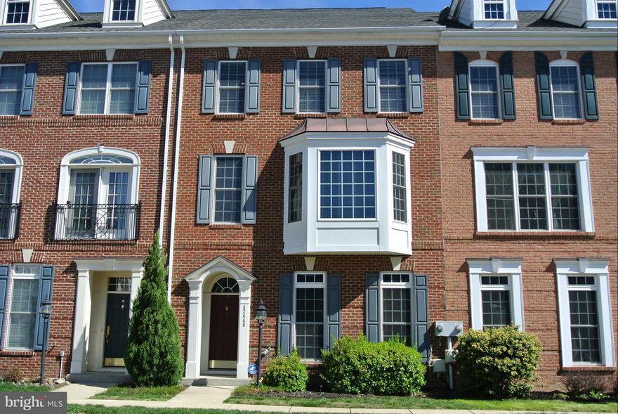 Incredible 4 bedroom townhouse in Brambleton. Walk to the Town Center, Park & Amenities! Enjoy almost 3200 finished square feet of living space. Beautiful 5" hardwoods grace the entire main level. Gourmet kitchen w/granite. Sunroom addition provides flex space to suit your needs! Middle level has owner's suite and 2nd bedroom. Third level offers 2 bedrooms, full bath & loft.  2 car detached garage