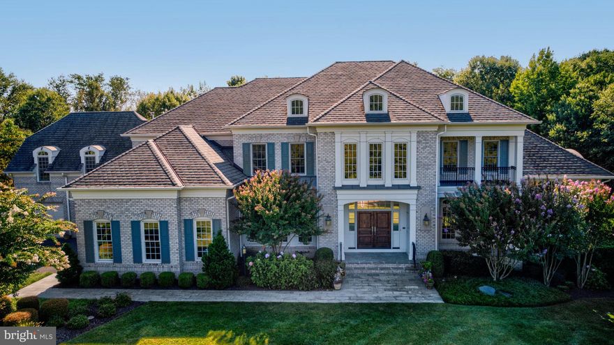 Multi-generational living at its best in this expansive Gulick Woodley model featuring  over 9000 square feet of living space with an elevator to all 3 levels and 2nd kitchen in the lower level. The home is perfectly situated in a desirable enclave with a gorgeous, flat, and private yard.  Upon entry, natural light floods the interior, highlighting the seamless flow between the gourmet kitchen, breakfast room, sunlit sunroom and cozy family room. Whether hosting elegant parties or casual gatherings, the versatile floor plan effortlessly caters to every occasion. The upper level offers a spacious owner's suite boasting three large walk-in closets and a spa-like bathroom as well as four additional bedrooms each with their own ensuite bathroom and walk-in closets. A versatile bonus room above the 4-car garage offers endless possibilities including second home office or potential bedroom. The lower level is a sanctuary for leisure and entertainment, featuring a full  kitchen and wet bar for casual get-togethers, or additional living space for extended family.  Unwind in the home theater, stay active in the exercise room, or engage in a friendly game of billiards or ping pong in this sprawling space with walk-up doors.  Outside, a spacious patio beckons, providing the perfect setting for alfresco dining and enjoying the serene surroundings. Seize the opportunity to make this extraordinary residence your own.