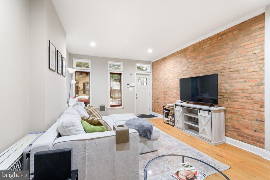 Welcome to 1107 S Ellwood Avenue, pristinely located just steps from Canton Waterfront Park, O'Donnell Square, and The Shops at Canton Crossing. This 13-foot wide home is located on a quiet beautifully tree-lined street, always with ample street parking. The main level of the home is spacious and open, with a large living room boasting plenty of natural light from the double windows. Before entering the kitchen, you'll find two row home bonuses... a powder room and coat closet! Thoughtfully laid out kitchen with plenty of cabinet storage, granite countertops, SS appliances and a breakfast bar. A more formal dining area also located just off kitchen/next to breakfast bar area. Just outside the french doors off the dining room, you'll find a private patio, perfect to extend entertainment outside. Upstairs you'll find the perfect row home layout with 2 bedrooms and 2 full baths. The primary bedroom will blow you away with its ceiling height, exposed beams, and natural light. Aside from this large room is a walk-in closet and updated full bath with walk-in shower (that also has smart controls to program preferred shower temperature and timing for each owner). Down the hall you'll find the 2nd updated full bath and side-by-side laundry. 2nd bedroom in rear of home, equipped with another set of french doors and with access to your rear composite deck! Last but not least, basement is partially finished, with the finished space perfect for a home office or home gym plus more than enough storage. Although no private parking pad, parking is never scarce on this block of Ellwood. Other updates include: 2021 - new range, silver coat on roof (originally replaced in 2019); 2019 - water heater and refrigerator; 2017 - new washer/dryer; major renovation took place in 2014/2015. Snag this meticulously kept gem before it's gone!