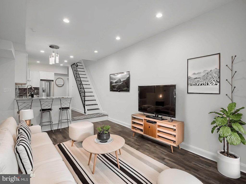 Recently renovated and perfectly situated, this spacious three-story home is just a short stroll from the Italian Market, Queen Village, and Passyunk Square. Step inside to an extra-long living room—ideal for entertaining or stretching out in comfort. The chef’s kitchen is a true highlight, featuring stainless steel appliances, counter seating, and a smart layout that flows into a convenient half bath and laundry area.
Upstairs, enjoy a sunny second-floor deck—perfect for morning coffee or your growing plant collection. This level also includes a full shared bathroom and a generously sized bedroom with its own ensuite bath. The third floor offers two more large bedrooms with ample natural light.
A clean, dry, and unfinished basement provides plenty of extra storage space. With easy access to public transportation and all the charm of South Philly just outside your door, this home is a standout in both style and location.