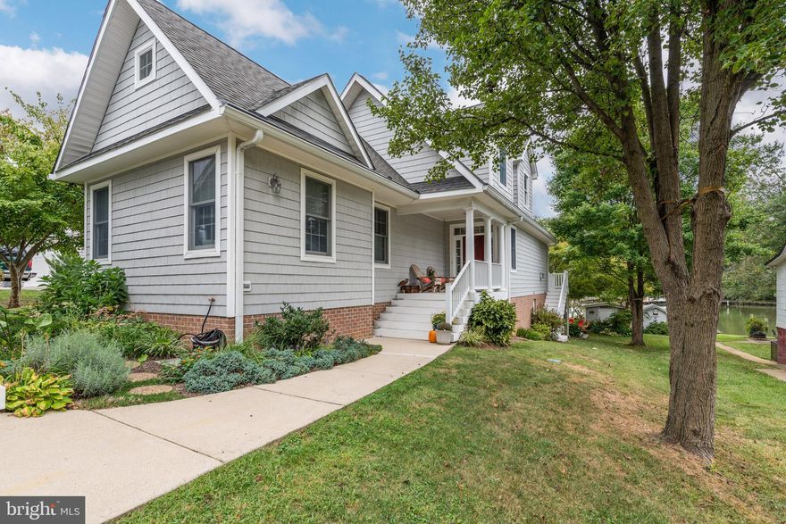 First time offered.  This Coastal Southern Living waterfront built in 1999 passed down as land from Seller's Grandfather in the 1930's.  This home will charm you instantly from the Gettysburg charcoal paver driveway to the covered front porch.  Stepping into the light filled and custom tiled floor two story foyer with skylight you then see the gorgeous kitchen as the hub of the open living areas.  Corian seamless counters and sink with white cabinetry and butler's pantry and oversized granite island/breakfast bar makes cooking and entertaining a breeze.  Casual eating area in front  of Bay window has gorgeous water view and living area is framed by one of the 2 propane gas fireplaces with remote and built-in bookcases and pretty moldings.  Main level boasts 9 foot ceilings.  Sliders lead to Trex deck facing south with Sunbrella awning and steps lead to yard with gentle slope to protected waterside with no flood insurance required.  Please check out the virtual and drone tour to see how quickly you can hit the Bay and downtown Annapolis!  Quality Anderson windows and doors, three convenient pocket doors, dual zone newer heat pumps with propane back up that allowed the seller to have a $88 electric bill last month!  Main level master suite with tray ceiling, private bath featuring brushed nickel handles on custom cabinetry and rain shower doors.  Big walk-in closet leads to mudroom that has a beautiful water view and space to do laundry with a smile.  White oak flooring from Western Maryland on the main level and up the stairs where there are 3 other bedrooms (or 2 more bedrooms and an office or craft room) and tons of walk-in dormer and attic storage.  Or blow out the dormers to gain more room and views.  Lower level has daylight walk-out family room with 2nd propane fireplace, full bath to shower after boating and a second kitchen for keeping the crabs and outdoor living from coming inside onto the tiled floors.  Gorgeous paved lower deck is covered to enjoy storms while keeping dry or to provide cover when cooking on the BBQ.  Unfinished portion of the basement is great dry storage and for workshop.  Classy Lanai is framed on another magnificent paver patio which draws in everyone and leads to private pier with deep water over 8 feet, boathouse shed and floating dock for your water toys.  Seller has been meticulous in using high end finishes and improvements which will make your upkeep minimal, such as vinyl Hardiplank looking siding, generator for power outages, propane tank as back-up heat, reverse  osmosis for always "good" water, duvet shades, central vacuum, 2 corner lit dining hutches, main level and upstairs wired for Bose speakers, 2019 6" gutters with gutter guards, home warranty, and many other thoughtful touches.  Annapolis address with Broadneck schools and quaint community of Whitehall beach which feels like country past the sod farm (in trust), but a short easy ride to downtown.  Voluntary HOA is $50 per year for social activities and community floating dock.  Seller is offering her 13 foot Boston Whaler with a Mercury engine if a mutually agreeable price is determined so you can start to living the Chesapeake Bay lifestyle immediately!  Fish and crab off your private pier.  Minnow Creek has a 6 mile speed limit so no fast boating here.  Enjoy serenity, ospreys, eagles and blue heron.