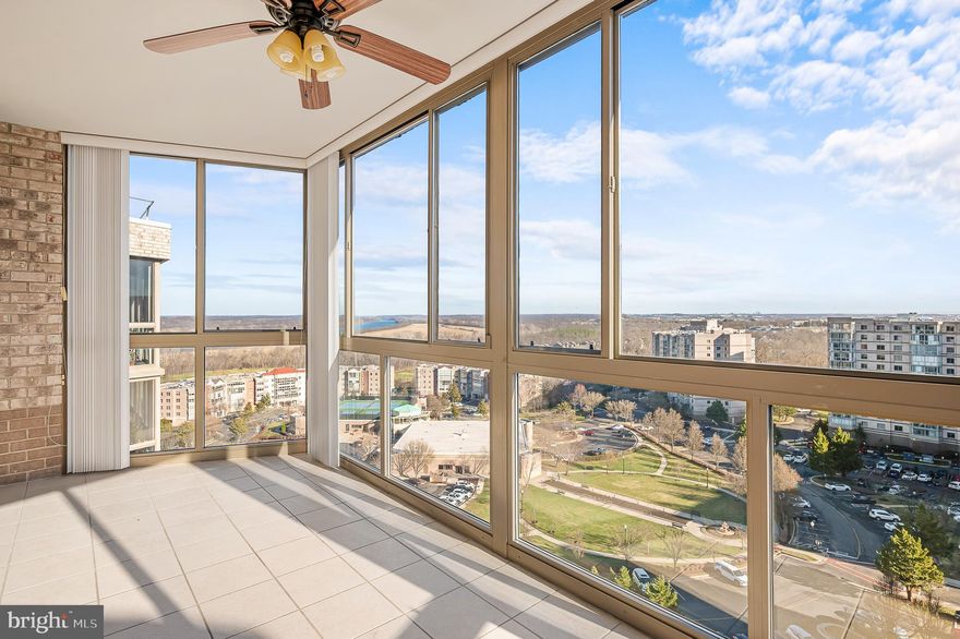 MAJOR PRICE REDUCTION! Don't miss this opportunity to enjoy the incredible views from this updated and exceptional condo in the highly sought-after 55+ community of Lansdowne Woods, offering a lifestyle of comfort, luxury, and convenience. Perched on the 11th floor, this stunning residence boasts breathtaking panoramic views of the Potomac River, community and lush greenery, creating a serene backdrop that changes beautifully with the seasons. This unit includes the ULTIMATE convenience of an INDOOR garage space (7-100), great for those rainy, windy or cold days.

Step inside and discover a bright, open floor plan designed for both relaxation and entertaining. The spacious living and dining areas are bathed in natural light, thanks to a sliding glass doors  that frame those spectacular views. The gleaming hardwood floors and neutral palette offer the perfect canvas for your personal style. The kitchen features quartz countertops, updated stainless steel appliances, ample cabinetry, and a cozy breakfast nook where you can enjoy peaceful mornings overlooking the horizon.

The primary suite is a tranquil retreat, complete with a generous walk-in closet and a beautifully updated en-suite bath. This spa-like sanctuary includes a quartz-topped vanity, a walk-in shower adorned with timeless subway tile, and striking black-and-white floor tiles for a touch of elegant modern flair. The thoughtful design doesn’t stop there—with an additional large closet, you’ll have plenty of room to keep your essentials organized and tucked away. A second bedroom and bath provide flexibility for guests, or a cozy den. The third bedroom was used as a home office and has a complete built in desk, shelving and plenty of storage.

But the crown jewel of this home might just be the enclosed sunroom—a versatile space perfect for sipping your morning coffee, curling up with a good book, or you slide open the windows and enjoy the breeze while simply taking in the sweeping vistas in all-weather comfort.  A storage unit conveys with the unit, Room #L-1 BIn 161.

Lansdowne Woods is renowned for its resort-style amenities. Residents enjoy access to a clubhouse featuring an indoor pool, fitness center, ceramics studio, library, art studio, woodworking shop, tennis courts, and a myriad of social activities. Plus, this gated community provides 24/7 security for peace of mind.

Located just minutes from shopping, dining, and medical facilities, Unit 1115 is not just a home—it’s a gateway to an extraordinary, worry-free lifestyle. Don’t miss your chance to own this slice of paradise.