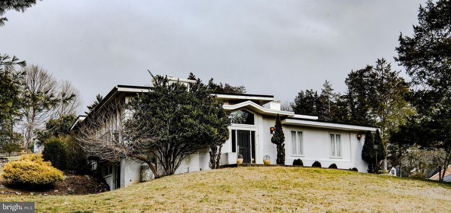 Jaw dropping price drop 75k off original list price for buyers to install new roof and make some repairs.  Seller wishes to sell the property as is, but it is a true showplace in the making! Bring it back to its glory! Stunning  contemporary less than half a mile from Shenandoah National Park’s Skyline Drive (Front Royal Entrance) on a welcoming corner lot in the beautiful Belmont subdivision.  Enjoy breathtaking sunsets over the surrounding mountains, four bedrooms, three full (completely updated) baths, plus nearly 3,600 finished square feet.  Appreciate the splendid 24x20 vaulted/beamed dining room (w/fireplace, cherry hardwood floors, two doors leading to a lovely balcony), expansive decking (including a hot-tub ready 12x10 deck off primary bedroom w/ pergola), great room w/ vaulted white pine ceiling, ceramic tiled kitchen with adjacent breakfast/sitting room (w/wood burning fireplace and bar with built in wine refrigerator).  

UPDATES INCLUDE: Nearly 60k in kitchen enhancements (including granite, a $3,500 Wolf 5 burner gas oven, convection microwave, Bosch dishwasher and more), many replacement windows (2006–approx $40k spent per owner), a $45k+ investment in lower level primary bedroom/bathroom finishings (to include a 13x9 bathroom completely handicapped accessible w/ multiple shower heads, a wheelchair roll in shower, eye catching built ins in master/rec room w/ adjacent 7x7 walk-in closet), 11k heat pump (2022ish), newer roof (approximately 15 years old), skylights, and more.

FEATURES TO NOTE:  Two primary bedrooms w/ attached bathrooms, two inviting entries (front door and side door off circular driveway entering from deck into great room), three fireplaces (in dining room, great room and sitting room), brilliantly designed architectural updates/opening of floorplan, 2 car garage (23x18), welcoming foyer w/ huge coat closet, cherry hardwood floors in bedroom wing hallway, marble floor and tiled tub/showers in main level bathrooms, timeless built in shelving in great room, lower primary bedroom/rec room and upper foyer/hall).  LOCATION:  Just 3 houses away from the national park and 1.5 miles away from the river, dog park, all levels of schools, downtown FroRo and more.