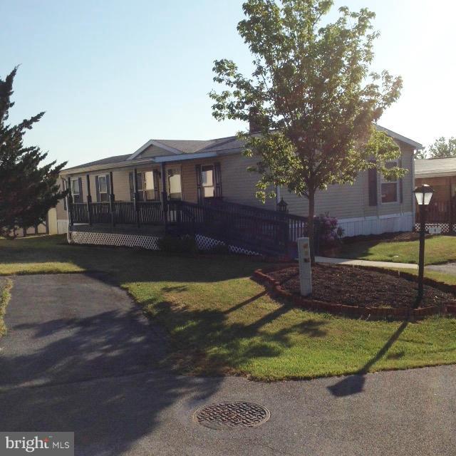 Double Wide home with Disability access. 3 bedrooms, 2 full baths, roomy kitchen and a bonus room that could be used as an extra bedroom or den. Some upgrades. Covered porch and deck. 2 sheds. All appliances convey.....gas stove/oven, refrig, dishwasher, washer and dryer. Park approval required. Home Warranty included.
