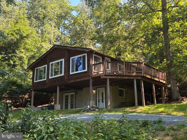 BACK ON THE MARKET WITH BRAND NEW SEPTIC!! ***** FEEL LIKE YOU ARE ON VACATION EVERY DAY! THIS HOME HAS STUNNING VIEWS OF THE LAKE AND NATURE, PLUS A PIER. BRING YOUR KAYAK AND FISHING ROD. HOME FEATURES A HUGE DECK FOR ENJOYING THE TRANQUIL SURROUNDINGS AND A LARGE CONCRETE PATIO OVERLOOKING THE WATER. 2 BEDROOMS AND 1 BATH ON THE UPPER LEVEL AND 1 BEDROOM AND FULL BATH ON THE LOWER LEVEL. GORGEOUS WOOD WALLS AND CEILINGS AND BEAUTIFUL HARDWOOD FLOORS. SPACIOUS LIVING ROOM WITH PANORAMIC VIEWS OUT OF EVERY WINDOW. DINING ROOM WITH BRICK FIREPLACE IS JUST OFF KITCHEN WHICH INCLUDES STAINLESS STEEL APPLIANCES AND PLENTY OF COUNTER SPACE. ROOF IS 2 YEARS YOUNG. LOWER LEVEL BOASTS A GUEST ROOM THAT WOULD ALSO MAKE A PERFECT HOME OFFICE AS WELL AS A LOVELY TILED OPEN SPACE PERFECT FOR A DEN OR FAMILY ROOM. IN ADDITION, A FULL LAUNDRY UTILITY ROOM IS INCLUDED. MAKE THIS YOUR PIECE OF PARADISE.