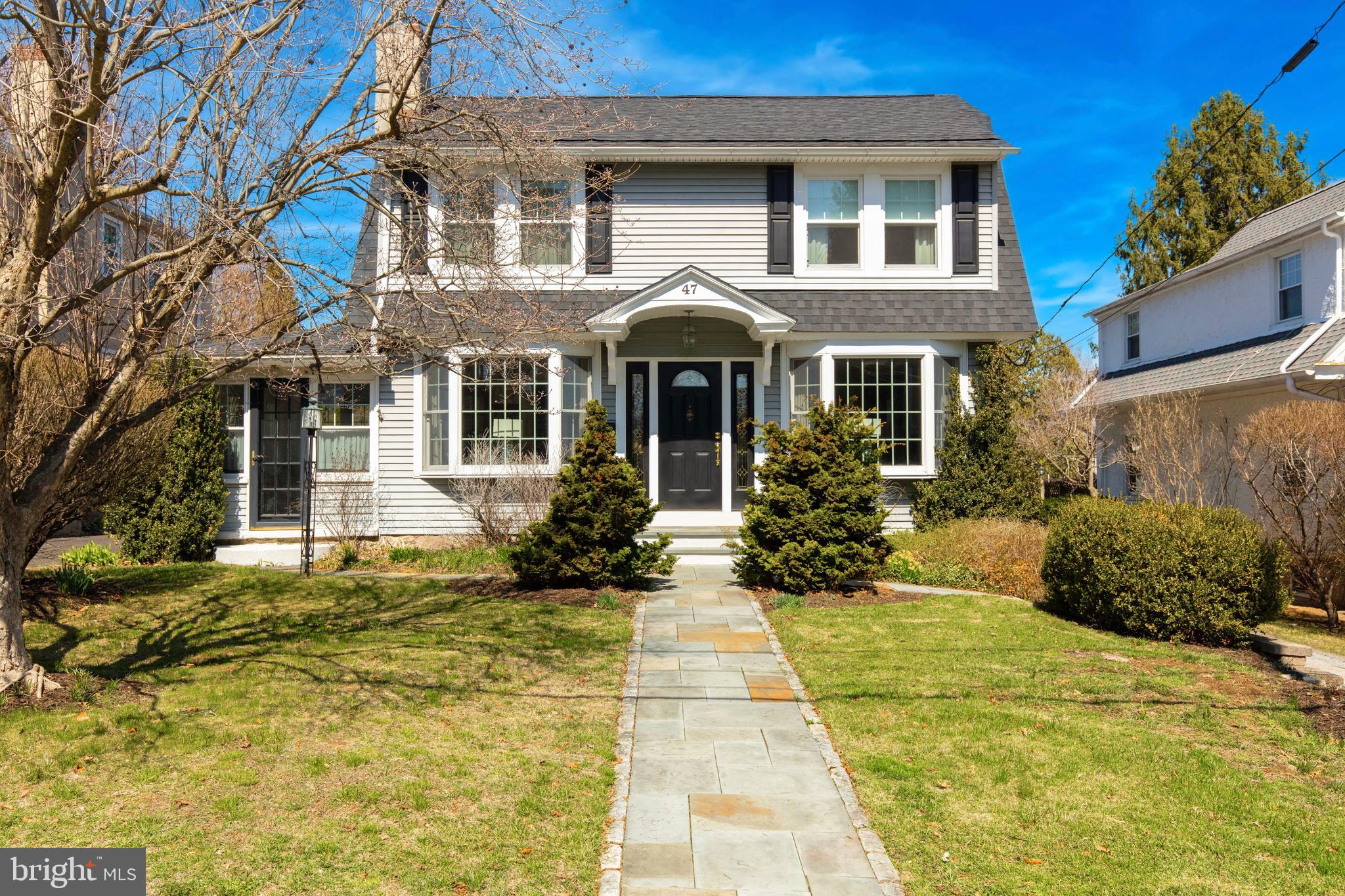 Charm abounds inside this beautifully maintained home in the heart of Flourtown. Step inside and be greeted by an abundance of natural light streaming through large bay windows, illuminating the inviting entryway. A handsome brick fireplace serves as the heart of the living room, complemented by extensive millwork that adds timeless character throughout.
The sunroom with its own outdoor access offers the perfect retreat for morning coffee. The formal dining room, accented by elegant pony walls seamlessly connects to the spacious family room through classic French doors—ideal for both intimate dinners and lively gatherings.
The kitchen is truly an entertainer’s dream! Featuring quartz countertops, a subway tile backsplash, and a generous breakfast bar, this space is designed for effortless hosting. The breakfast area, with its charming shuttered windows, overlooks the backyard and provides direct access to the rear deck —perfect for indoor-outdoor living. The family room is equally inviting, with windows that frame serene views of the lush gardens.
Ascend to the second level to discover three generously sized bedrooms, all with ample closet space and beautiful hardwood floors. The full bath offers built-in storage and a single vanity; while the spacious primary suite is a true sanctuary, boasting two large closets and an en-suite bath with a double vanity, granite countertops, a stall shower, and a built-in linen closet. Adding to the home’s convenience, a tiled laundry room is tucked away just off the primary bath.
With a versatile floor plan, timeless design elements, and a prime Flourtown location near shopping, parks, and major travel routes, 47 Grove Avenue is a must-see! Located in the highly acclaimed Springfield Township School District. Schedule your showing today and experience the perfect blend of charm and modern living.