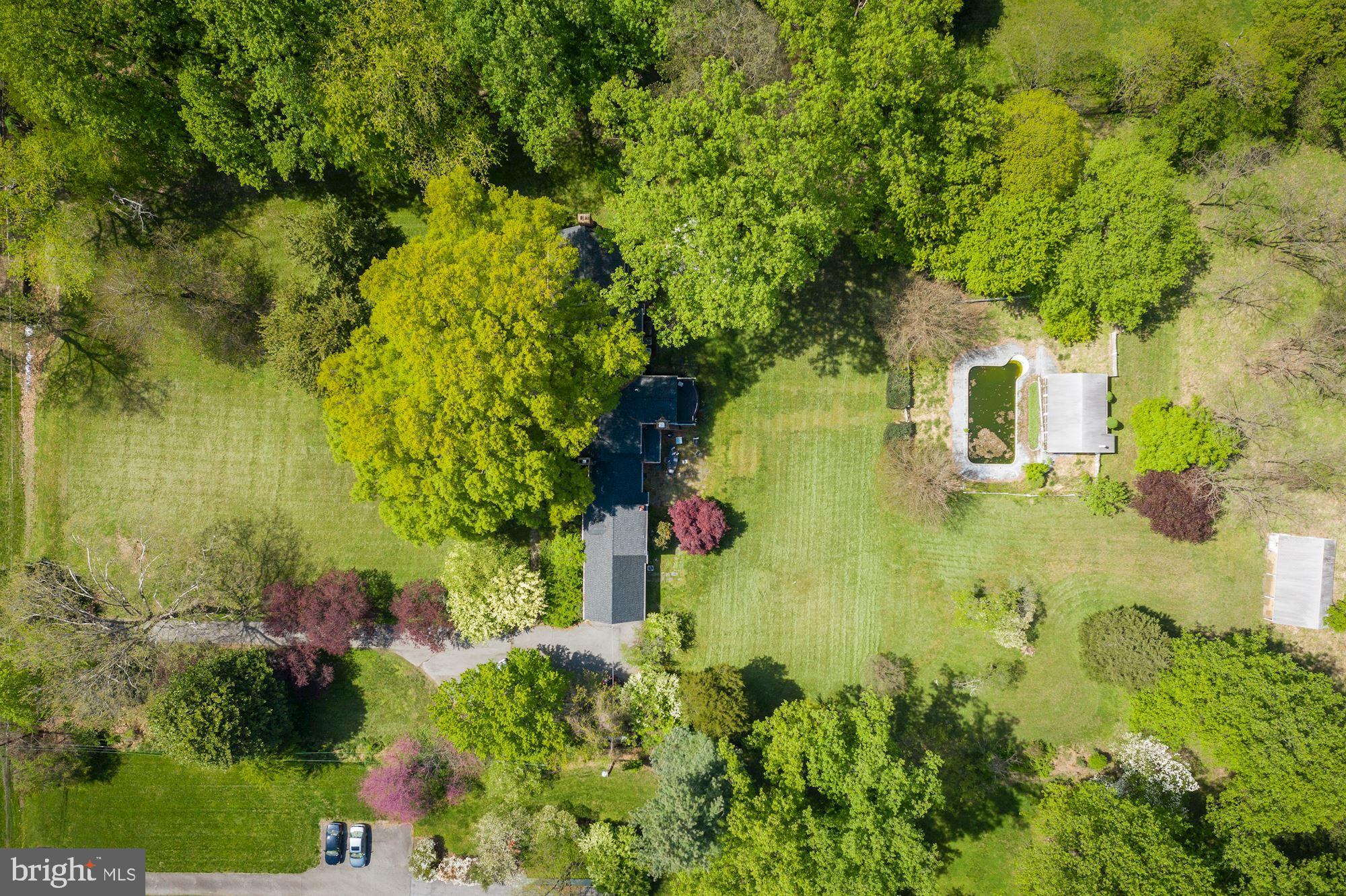Take a look at the attached AERIAL VIDEO of this property to appreciate the beauty of this land. An incredible opportunity to own almost four estate quality acres in the heart of the Potomac Village. The picturesque site, with sprawling grasslands and mature trees, provides tranquil and private setting, perfect for a refuge from the bustle of Washington DC. Built in 1955, the original country estate included a charming Williamsburg colonial, a swimming pool, a cabana, and a barn. This classic "Old Potomac Home" was renovated sometime in the mid-nineties, at which time the property was connected to the public sewer. The two upper levels of the home offer 4600 square feet of living space. The elegant, embassy-sized living and dining rooms, both with fireplaces, a library/office with a wet bar, a country kitchen with a huge fireplace and a spacious keeping room/breakfast room, a family room just off the kitchen, a screen porch, a powder room, and an au pair suite are all located on the main level. Upstairs, there is a primary suite with a fireplace and two separate, en-suite bathrooms, tree spacious bedrooms, two additional baths and a walk-in attic. The finished lower-level room is perfect for a playroom or a media room. The home features hardwood floors throughout, lots of built-ins, both for display and for storage, and many windows and glass doors that bring in the natural light and offer great views of the grounds. Set on a bucolic street, just off the prestigious River Road, this property is located on a beautiful block with several multi-million $$$ properties, very close to the Village center (0.6 miles), and within an easy reach of major commuting routs, three airports, the area's fine shopping, dining, schools, and wide range of museums, sports venues, and cultural centers. Truly a one-of-a-kind property, unlike anything else in this area. Exceptional and rare opportunity to either renovate/expand the existing home or to build your own dream estate.