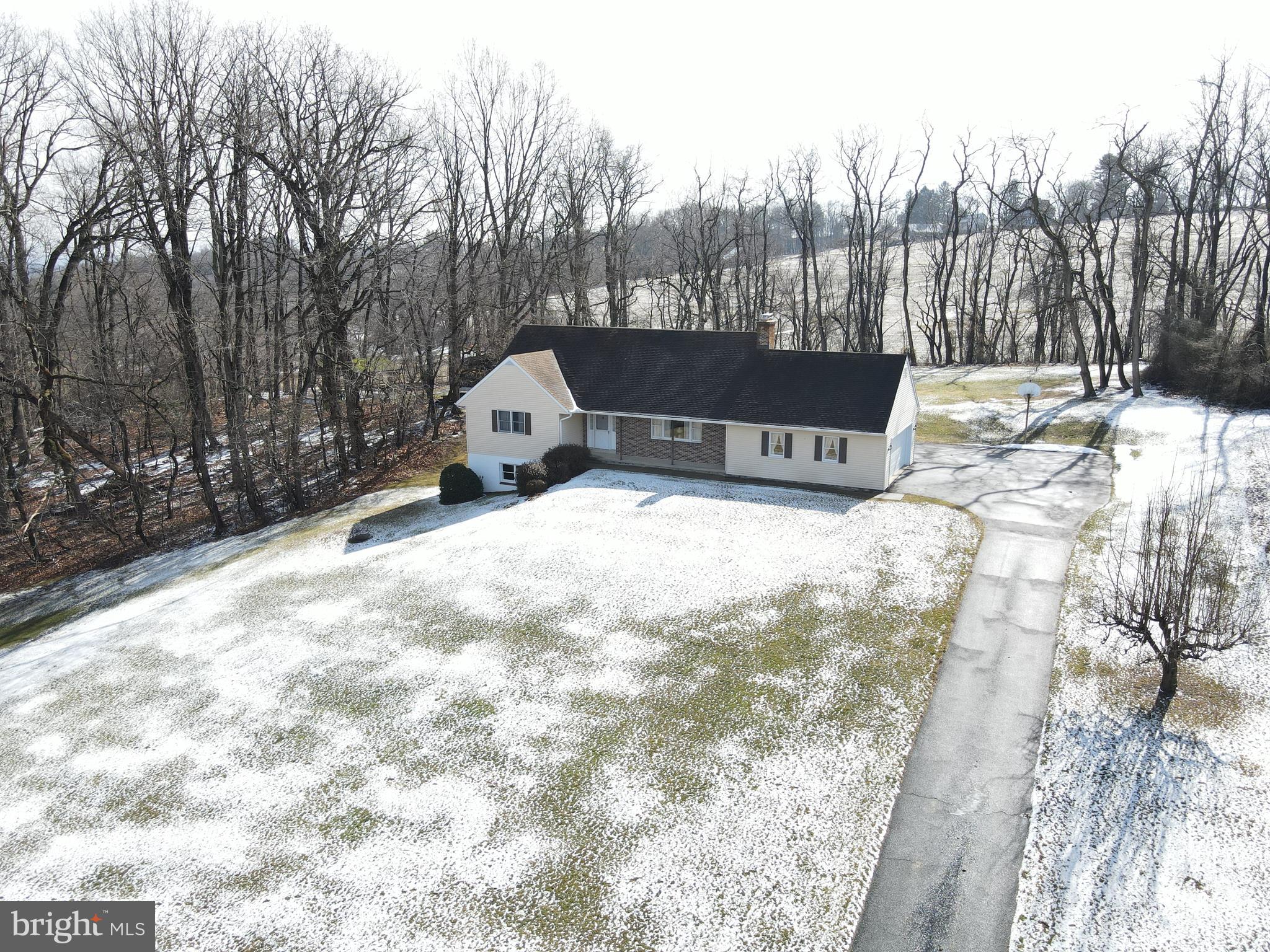 This property will be offered at Public Auction on Saturday, April 12, 2025 @ 12pm. The listing price is the opening bid only and in no way reflects the final sale price. 10% down due at auction, 2% transfer tax to be paid by the purchaser, real estate taxes prorated. This custom built one owner home, elevated on a 2.4 acre country lot, offers beautiful scenic views and a small portion of tillable acreage. The first floor of the cape cod style home features a spacious living room with a fireplace, an eat in kitchen with both basement and garage access plus a convenient powder room and laundry area. This floor also offers two bedrooms and a full bathroom. Upstairs, you will find two additional bedrooms and another full bathroom. The unfinished basement offers access to the back yard, a workshop space, canning cellar, and storage. Additional amenities include an attached garage, a concrete block shop, a pavilion with a brick barbeque grill, perfect for entertaining friends & family as well as ample storage and closet space throughout the home! This is a great family home opportunity in Lancaster County!