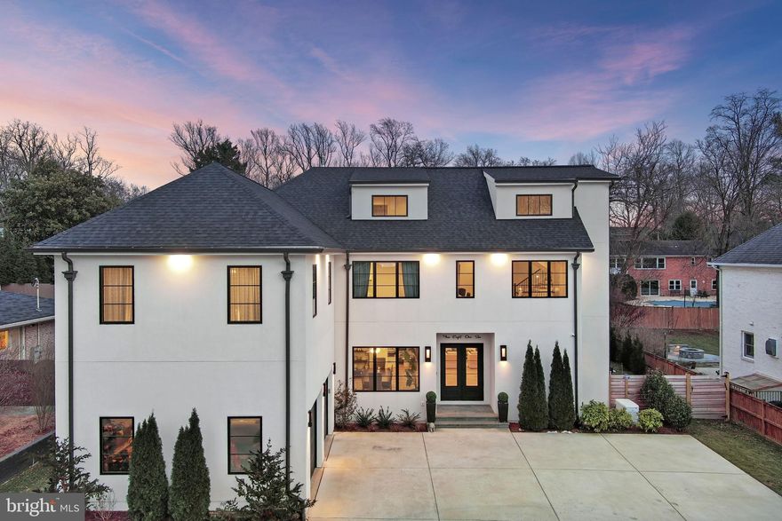 Discover unparalleled luxury and elegance in this 8,300+ sq ft custom-built home located in the prestigious Kenwood Park community of Bethesda, Maryland. Perfectly positioned on a flat, professionally landscaped 0.29-acre lot within the top-rated Walt Whitman High School district, this exceptional residence offers a rare blend of modern amenities, exquisite craftsmanship, and sophisticated design.
Featuring 5 spacious bedrooms, 6 full bathrooms, 2 half baths, and an elevator servicing all four finished levels, this home is ideal for upscale family living and grand-scale entertaining. The open-concept floor plan is bathed in natural light and adorned with designer finishes, including custom tile work, high-end cabinetry, and hardwood flooring throughout.
At the heart of the home is a gourmet chef’s kitchen, fully equipped with premium Sub-Zero wine storage, refrigerator drawers, a large center island, two dishwashers, and a walk-in pantry—perfect for hosting and everyday culinary excellence. The family room features reclaimed wood ceiling beams and a statement fireplace, blending rustic charm with modern elegance.
A  home office on the main level provides space for work or study. Additional features include a custom mudroom with built-in cabinetry and a dog washing station, two laundry rooms, a central vacuum system, custom lighting, and smart home technology with integrated speakers and surveillance cameras for security and convenience.
The luxurious owner's suite is a serene sanctuary boasting a spa-style bathroom with a freestanding soaking tub, steam shower, and custom walk-in closets. Each bathroom throughout the home showcases bespoke tile work and designer fixtures.
Step outside into a true backyard oasis. Designed for year-round enjoyment, the outdoor living space includes a covered patio, wood burning fireplace, built-in grill, pizza oven, and a heated saltwater pool with an automatic safety cover. The fenced yard, custom hardscaping, and full irrigation system create a peaceful, low-maintenance retreat.
Additional highlights include a circular driveway, oversized 2-car garage with built-in storage, and a generator for uninterrupted comfort. Enjoy the unbeatable walkability to downtown Bethesda, with access to premier shopping, dining, and entertainment just minutes away.
This one-of-a-kind Bethesda luxury home combines timeless architecture, cutting-edge features, and an unbeatable location, making it the perfect investment in lifestyle and real estate.