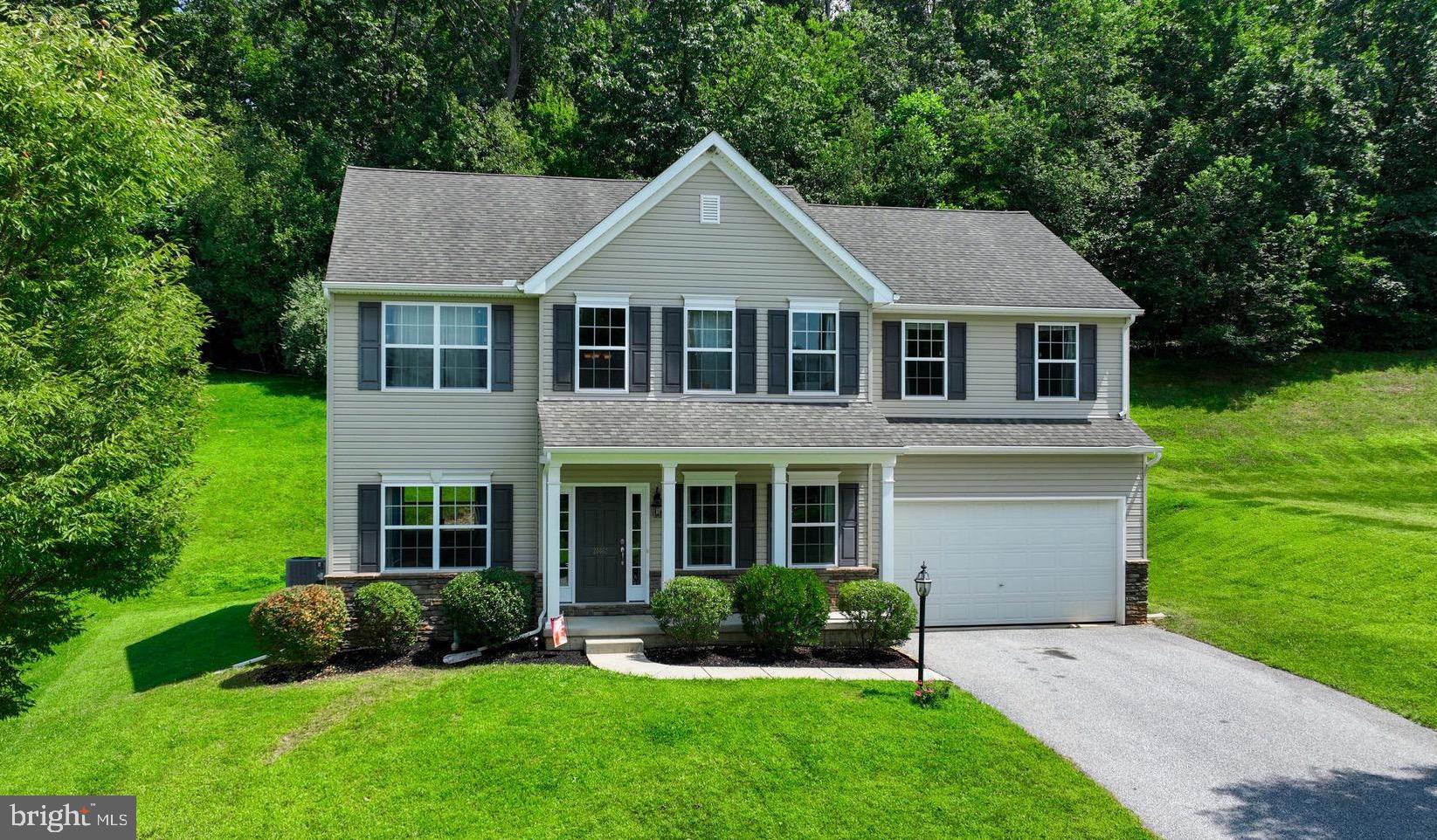 Welcome Home! Step inside the two-story foyer and be greeted by a formal living room and dining room that flow seamlessly. The kitchen features stainless steel appliances, a center island, and a cozy breakfast area with access to the rear deck. The kitchen opens to a large family room centered around a gas fireplace with a modern stone surround. Hardwood flooring flows throughout the main level, which also includes a private first floor office - ideal for remote work or study. The spacious primary suite boasts a luxurious en-suite bathroom with double door entry, Venetian-Style walk in shower, soaking tub, dual vanities, & walk in closets. Three additional bedrooms and a full guest bath complete the upper level. The lower level is ready for future expansion - perfect for home theatre, gym, or additional living space. Enjoy outdoor living with a covered front porch, a rear deck, and beautifully maintained landscaping. Located just minutes from I-83 and the PA/MD line!