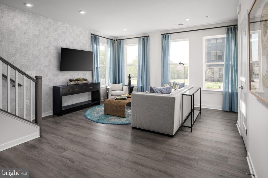 The open-concept design of The Tessa allows for ease of living and entertaining from the kitchen to the main family room whether that means a casual dinner on the couch or hosting happy hour with friends. The front of the condo has three large windows allowing for natural light to flood the space, making it feel even more spacious and open.

The family room is spacious enough for a sectional and is connected to the dining space and kitchen. In this 3-bedroom condo with a gourmet kitchen designed to impress, the quartz countertop peninsula offers seating for 5 and ample space for laying out appetizers or having quick meals while working from home.

The oversized primary suite on the second floor is big enough to make you feel like you’re in a single family home. It has an en-suite bathroom, double vanities, two walk-in closets, and a private water closet. Next to the primary bedroom on the second level, you will find two additional bedrooms with a hall bathroom.

*The photos shown are from a similar home. *