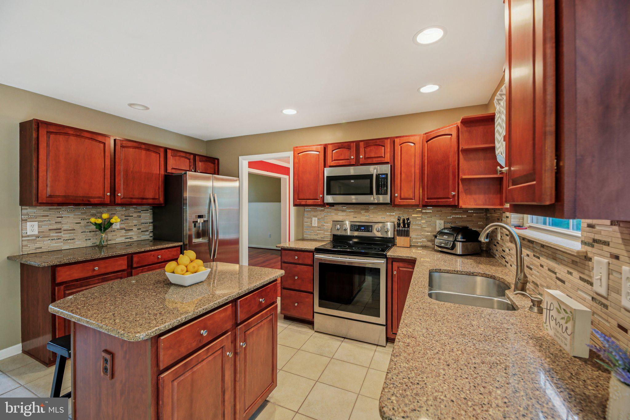 Your little slice of heaven awaits you! As you enter the two-story foyer, you'll know right away that this home is special. Beautiful cherry hardwood floors throughout the foyer, living room, and dining room. The eat-in kitchen has ceramic tile floors, quartz counters, stainless steel appliances, custom backsplash, and an island. Right off of the kitchen is the huge family room that is perfect to gather with family and friends or you can enjoy your expansive, freshly stained deck. The lower level offers a 5th bedroom or fitness room, half bath, wetbar along with a second family room that includes a gas stove. From the second family room, you can walkout onto your beautiful patio that includes a hot tub and paver steps to the front yard. The upper level features the primary suite and three spacious bedrooms, and a large hall bathroom. The primary suite includes dual walk-in closets. The primary bathroom includes a soaking tub, dual sinks, and separate shower. This home is situated in a lovely community that has sidewalks to enjoy your evening strolls. The community is minutes from downtown New Windsor and Westminster shopping and restaurants.