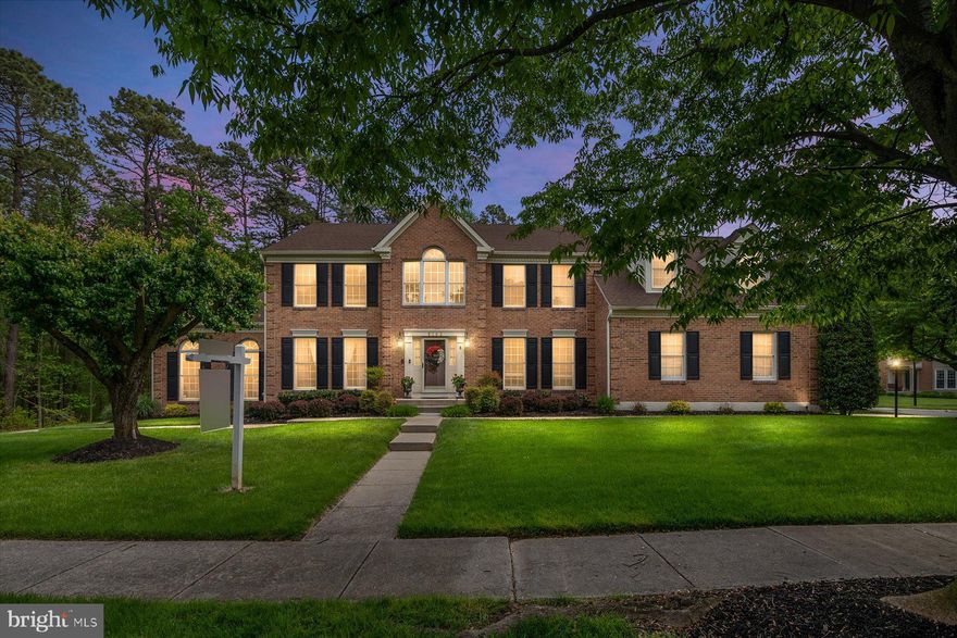 ** OPEN HOUSE Weekend both days 11am to 1pm! The Desired and well-maintained Community of "Quarterfield Farms" is proud to offer this FORMER MODEL HOME! This Meticulously maintained 4708 SQFT Brick Front Colonial with 2-car Garage sits perfectly on a very PRIVATE CORNER LOT.  The manicured Green Lawn is here to enjoy along with the exquisite landscape and hardscape, an efficient underground irrigation system and a truly MAGICAL exterior light display! Privacy is all around with backing to common area and trees with private woods (forest conservation) on the side yard. Enjoy entertaining at home with the outdoor space, the extensive Brick Paver Patio and the LARGE almost half Acre of land!  Upon entering the front door you are immediately WOWED by the Grand Staircase,  2-story foyer, Significant Crown Moldings and the Pristine Hardwood Floors! The Main level offers a rare to find Full Bathroom with Dual Entry doors accessed by the Hallway and the Bedroom/Office space.  Upgraded Kitchen has custom high-end soft close Cabinets, Stainless Steel Appliances, Granite Countertops & Island, Granite Coffee area/ Dry Bar and steps down to the Family Room that is complete with NEW LTV Floor, White Brick Wall Fireplace & Custom Mantel, Cathedral Ceiling and walk out to backyard patio!  Behind the kitchen is a mudroom and laundry area that leads to the attached garage - convenient for bringing in groceries and staying dry in inclement weather.  Entertainers will LOVE hosting dinner guests here in the formal dining room and relaxing with coffee or wine in the formal Living Room. That special spot in the home is an incredible 2nd family room that is light filled by atrium windows, has a striking cathedral ceiling and two sets of Glass French Doors. For more fun and larger gatherings the Fully Finished Basement is ideal for hosting Game Nights with a Cinema Projector System, Surround Sound System, Bar Area, Game Room and a Full Bathroom.  Upstairs on the 2nd level, you will LOVE the NEW Custom MARBLE Full Bathroom in the Hall, offering Gleaming Marble Floors, Dual Marble Vanity with soft close cabinets and a Marble Shower! 4 Large Bedrooms on the upper level inclusive of the Primary Ensuite with walk in closet, extra room for sitting area or an exercise bike or both, separate tub and stand-up shower with dual vanities in bathroom.  Some other items to note are: Upgraded Dual Zoned HVAC, 50 Year Architectural Shingles, New Hot Water Heater, ADT Alarm System, Audio System throughout interior of home, Back up Sump Pump, Hardwood Blinds, Recessed lighting and a pull-down attic for even more storage.  Fantastic Location with easy commute to DC, Balto, Ft. Meade, Annapolis & BWI Airport. Close to Great Restaurants, tons of shopping, BRAND NEW Old Mill High school and the Trail! Run... do not walk to this BEAUTY!!