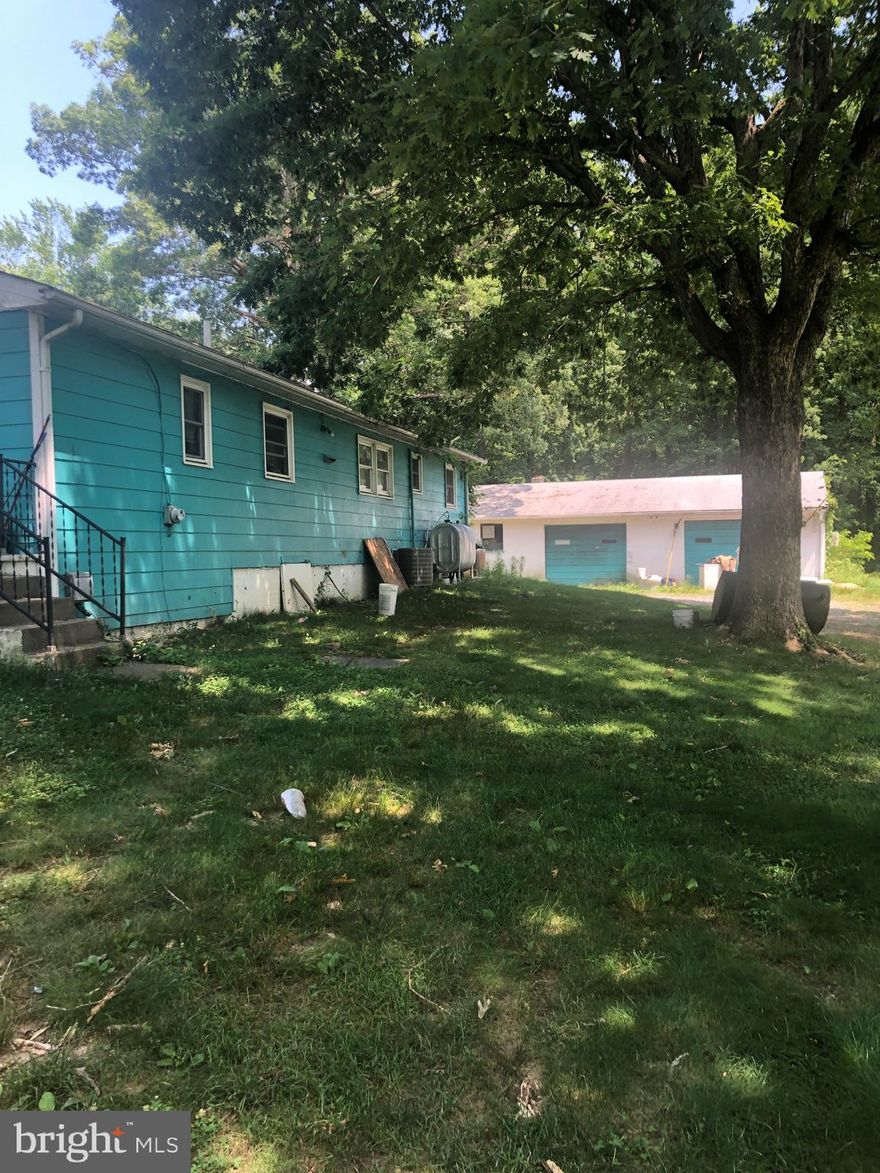 Investment Property available just a few miles from the town of Bowling Green.  This is a good fit for someone who wants to update the property to its full potential.  Currently all systems are in working order. Beautiful and quiet country setting.  The detached 2 + car garage was once used for Mr. Graves HVAC business.  This building has electricity and a ton of space for several cars and a workshop.  Patio on back of this building was used as a space for grilling/cook outs.  Almost one acre - Plenty of space for a large garden.