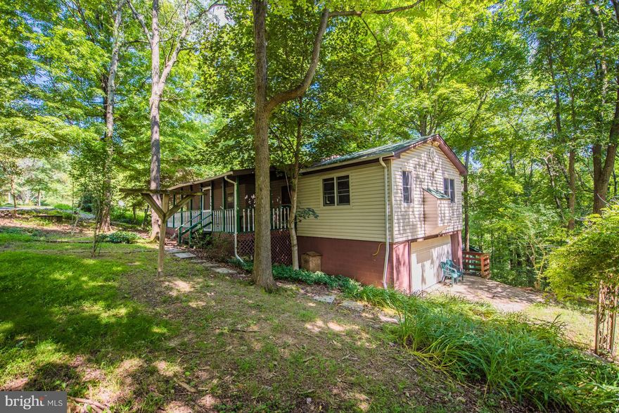BACK ON MARKET.    3 BR, 3 bath raised ranch on 2.239 acres features propane fireplace in living room, screened-in front porch,  hardwood floors, family room on lower level w/ pellet stove and wet bar, 2 car garage, carport, workshop,  two decks,  and 2 sheds. Close to GW National Forest, Trout Pond recreational area, Lost River and state parks.  New roof 2014. Thermal pane windows.