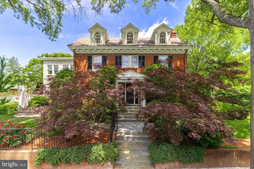 Perched on a prominent corner lot in Woodley Park, this stately colonial blends classic architecture with designer elegance across 6 bedrooms and 4.5 baths. Designed by Annie Elliott, every inch of the home is beautifully curated—from the gleaming hardwood floors to the layered, livable spaces. The formal living room, anchored by a fireplace, flows seamlessly into a light-filled sunroom, while the formal dining room opens to a beautifully updated kitchen and adjacent family room with a second fireplace. Step outside to a gorgeous patio and private backyard, perfect for relaxing or entertaining. Upstairs, the second level features three bedrooms including a generous primary suite and a versatile flex space—ideal as an additional living area or home office. The top floor offers two more bedrooms and a full bath with tranquil views of the National Cathedral. Downstairs, a complete in-law or au pair suite includes its own living and dining areas, kitchenette, bedroom, full bath, and private entrance. Driveway parking with EV charging adds everyday convenience. Located in the sought-after Woodley Park neighborhood, enjoy nearby conveniences like the Washington National Cathedral, Whole Foods, top-rated restaurants, shops, gyms, close proximity to private schools and inbounds Eaton Elementary.