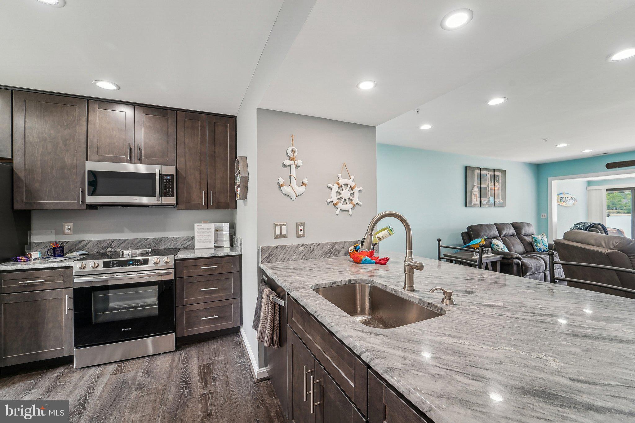 Welcome to Queens Landing, where resort-style living meets the comfort of home. This beautifully updated townhome offers 1,440 square feet of thoughtfully designed living space plus an open sunroom, adding approximately 160 additional square feet, creating a seamless and spacious floor plan ideal for everyday living and entertaining.
Enjoy panoramic water views from every room - lake and fountain views from the kitchen and second bedroom, serene Macum Creek views from the living area, and expansive Chester River vistas from your sunroom and private patio. Wake up to breathtaking sunrises and wind down under the motorized awning as boats pass by in the distance.
This two-bedroom home features dual en-suite baths, including a fully remodeled primary bathroom with a custom walk-in shower and sliding barn door. The kitchen is equipped with newer, beautiful soft-close cabinets, sleek countertops, modern appliances, and an extra pantry for added storage. Luxury vinyl plank flooring flows throughout the main level, while plush carpeting offers comfort upstairs. Additional highlights include a newer HVAC system, water heater, and fresh paint throughout. An expansive attic and a dedicated storage room provide plenty of space to keep your belongings organized and out of sight.
The building exterior was rehabilitated in 2018, including new windows, and a 30-year architectural shingle roof was installed in 2021. All required annual inspections have been completed, ensuring peace of mind.
Queens Landing offers unmatched community amenities including a waterfront pool, fitness center, clubhouse, pickleball and tennis courts, walking trails, and kayak launch areas—all just minutes from Route 50 and the Bay Bridge. This is your opportunity to own a turn-key waterfront lifestyle in a vibrant and well-maintained community.
The seller is also offering a 30-foot boat slip at the Queens Landing Marina with dues paid until March of 2026 and is selling a 2019 Sportsman 28-foot center console boat (grey/white with twin 200 Yamaha engines), available separately upon request. It’s the perfect combination for any boating enthusiast; a true boater’s dream.