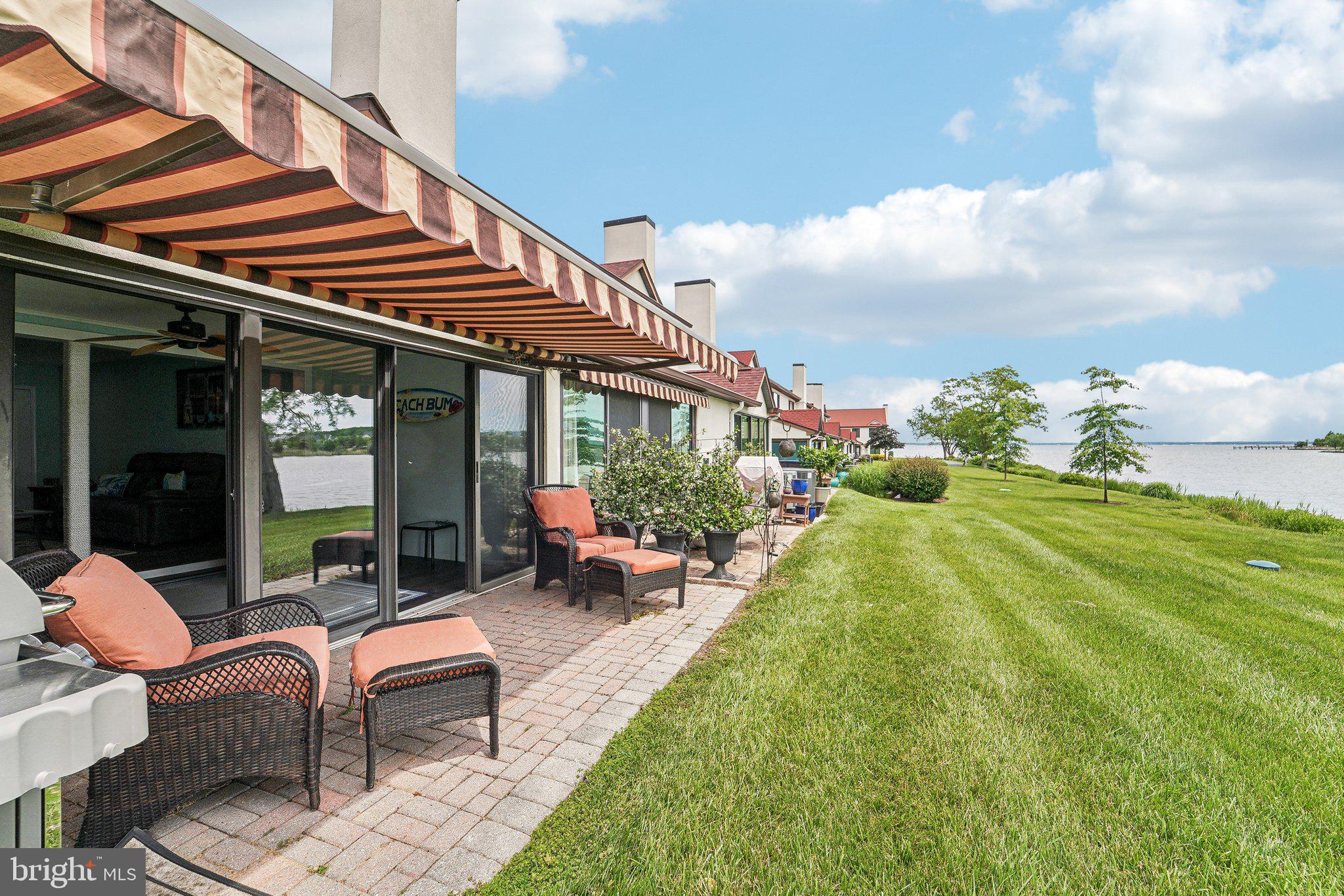 PRICE IMPROVEMENT!! Welcome to Queens Landing, where resort-style living meets the comfort of home. This beautifully updated townhome offers 1,440 square feet of thoughtfully designed living space plus an open sunroom, adding approximately 160 additional square feet, creating a seamless and spacious floor plan ideal for everyday living and entertaining.
Enjoy panoramic water views from every room - lake and fountain views from the kitchen and second bedroom, serene Macum Creek views from the living area, and expansive Chester River vistas from your sunroom and private patio. Wake up to breathtaking sunrises and wind down under the motorized awning as boats pass by in the distance.
This two-bedroom home features dual en-suite baths, including a fully remodeled primary bathroom with a custom walk-in shower and sliding barn door. The kitchen is equipped with newer, beautiful soft-close cabinets, sleek countertops, modern appliances, and an extra pantry for added storage. Luxury vinyl plank flooring flows throughout the main level, while plush carpeting offers comfort upstairs. Additional highlights include a newer HVAC system, water heater, and fresh paint throughout. An expansive attic and a dedicated storage room provide plenty of space to keep your belongings organized and out of sight.
The building exterior was rehabilitated in 2018, including new windows, and a 30-year architectural shingle roof was installed in 2021. All required annual inspections have been completed, ensuring peace of mind.
Queens Landing offers unmatched community amenities including a waterfront pool, fitness center, clubhouse, pickleball and tennis courts, walking trails, and kayak launch areas—all just minutes from Route 50 and the Bay Bridge. This is your opportunity to own a turn-key waterfront lifestyle in a vibrant and well-maintained community.
The seller is also offering a 30-foot boat slip at the Queens Landing Marina with dues paid until March of 2026 and is selling a 2019 Sportsman 28-foot center console boat (grey/white with twin 200 Yamaha engines), available separately upon request. It’s the perfect combination for any boating enthusiast; a true boater’s dream.