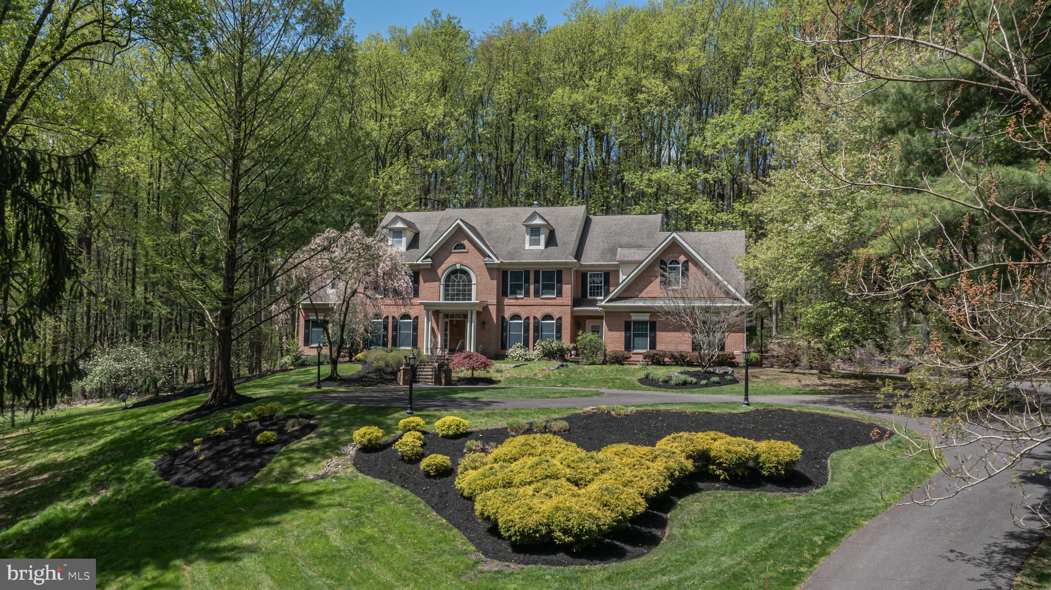 Stately Brick front Colonial located just minutes to Peddler's Village in Bellinghamshire Estates. Set back in a park-like neighborhood up a Governor's driveway is this elegant and spacious home. Featuring 5 Bedrooms and 4.5 Baths with all the amenities one desires including a rich, cherry paneled Study for convenient working from home, a Conservatory with walls of windows showcasing the beautiful, natural backdrop and 2 story Gathering Room with gas fireplace. The nearby Kitchen also boasts a gas fireplace creating wonderful ambiance for homecooked meals. The Living Room and Dining Rooms are adorned with original murals of the renowned artist, Carol Nagel, featuring Revolutionary era Philadelphia and Solebury Township. The Primary Suite offers tremendous walk-in closets and sitting area. The third floor Bonus Room has wonderful versatility and can potentially be an additional bedroom if desired. The Finished Lower Level allows for even more living space and features a fireplace, wet bar, media area, billiard room, additional bedroom and a full bath that walks out to a patio. Four car attached garage and located within New Hope-Solebury schools.