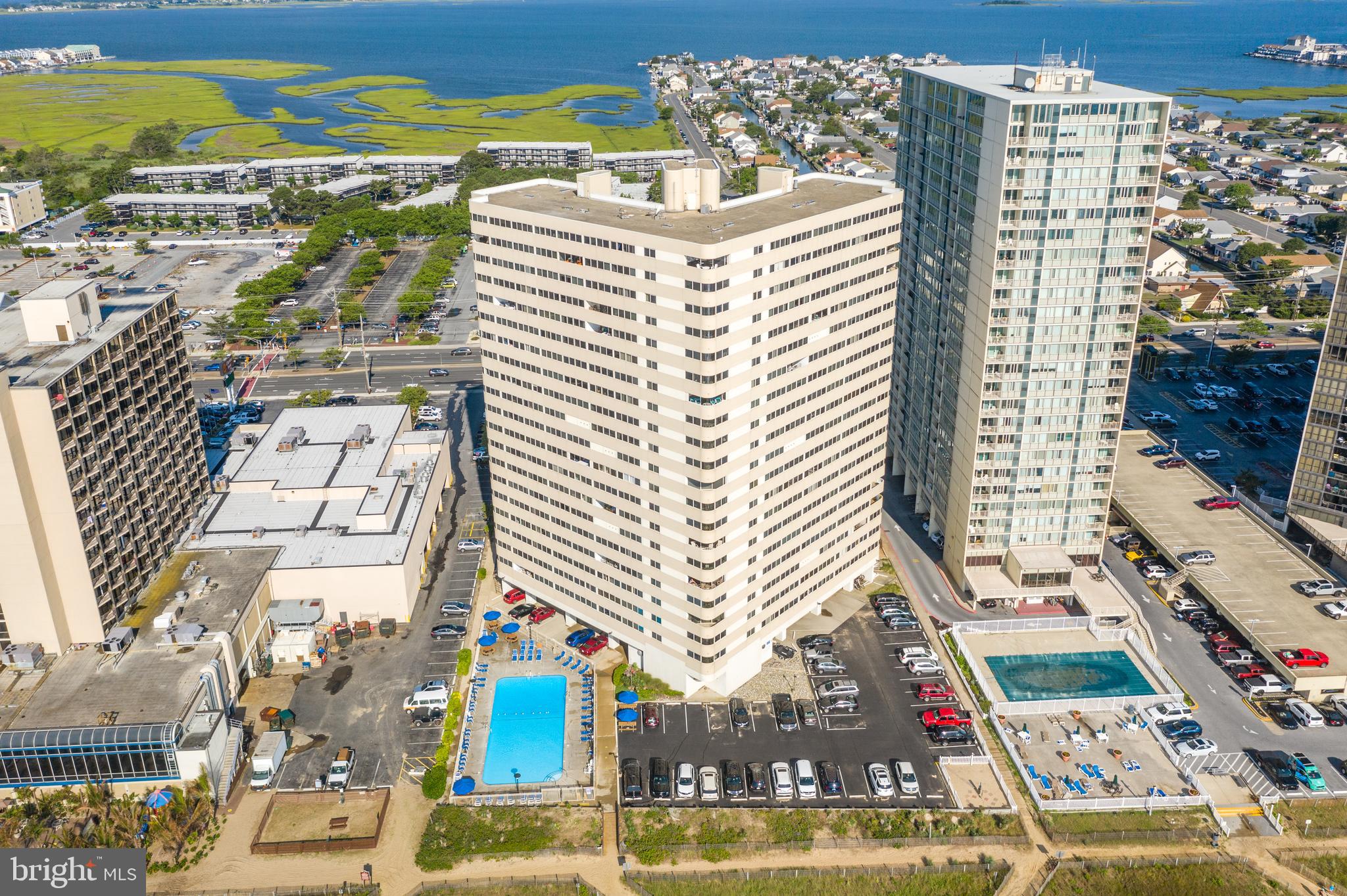 Welcome to your dream beachfront getaway! This beautifully maintained two-bedroom, two-bathroom oceanfront condominium is the perfect blend of comfort, style, and location. Lovingly cared for as a non rental second home, it features numerous upgrades and thoughtful improvements throughout. Step inside to find luxury vinyl plank flooring laid diagonally for a modern, upscale look that flows throughout the entire unit. The direct oceanfront view is simply breathtaking—unobstructed and panoramic, thanks to neighboring buildings being set further back from the shoreline. The enclosed balcony serves as a versatile, four-season room—ideal for enjoying sunrise coffee, evening cocktails, or simply listening to the soothing sound of the waves year-round. The living room is bright and welcoming, with a queen sleeper sofa for extra guests. Each bedroom offers ensuite bathrooms, providing privacy and convenience. The primary bedroom (which is ocean front) features a luxurious king-sized bed, while the guest bedroom includes a comfortable queen-sized bed. A convenient beach closet is located just inside the entryway—perfect for storing sandy gear after a day on the shore. The kitchen has been fully updated and designed for both function and style. It features stainless steel appliances, Silestone countertops, soft-close drawers and cabinets, and ample storage. A wall was removed in 2015 to open up the view and create a more spacious feel, and an eat-in counter was added to enhance the layout. Other upgrades include: A full-size expanded shower in the second bathroom (2009). Glazed bath/shower in the master bathroom (2009). Full condo flooring update with Luxury Vinyl Plank (2010). Kitchen renovation with new cabinets, backsplash, (2015), HVAC (2020), washer & dryer (2018) and other appliances (2015). Located in the sought-after Atlantis building, you'll enjoy a wide range of amenities: Outdoor pool, year-round security staff, direct beach access, ground floor bathrooms with showers and changing rooms, pet lot for your furry friends, double-pane windows for added comfort and the condo fee includes Direct TV streaming and WiFi. When you're ready to explore, you’re just minutes away from restaurants, shopping, grocery stores, movie theaters, and mini golf. For additional peace of mind a 1 year AHS warranty is included. Whether you're looking for a second home, a rental opportunity, or a permanent oceanfront residence, this is an exceptional value for a two-bedroom, direct oceanfront property. So what are you waiting for? Your place at the beach is ready—come make it yours!