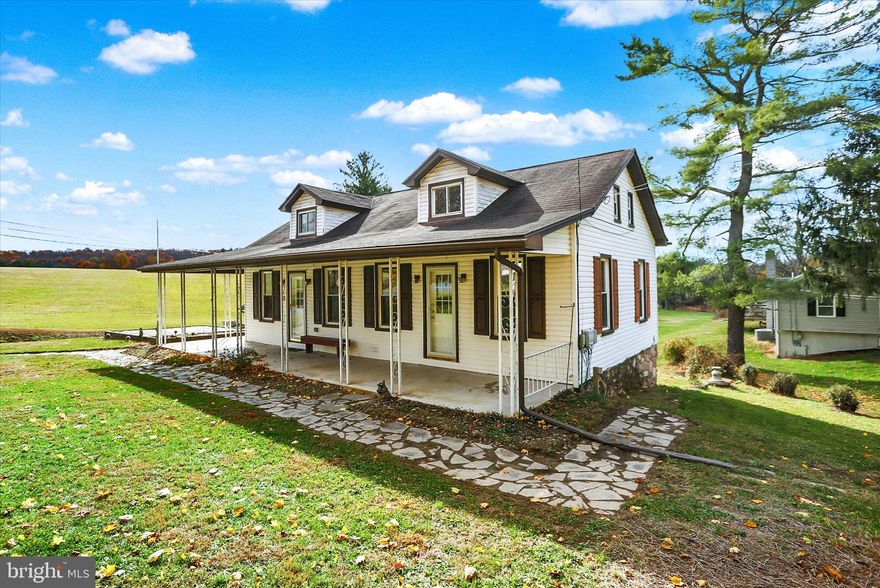 Welcome to a well-maintained Cape Cod situated on just shy of one acre, minutes from the Susquehanna & Appalachian Trail. Built by Lee Owens and owned by the same family for over 60 years. With more than 1,400 sq ft of living space on nearly one acre, this property combines craftsmanship with updates and the peaceful charm of simple country living.
Step inside to find real wood floors, beautiful, freshly painted interiors, and recent remodeling, making this home move-in ready. The main floor features a living room, dining room, two bedrooms, a full bath, and a cozy kitchen with a brand-new electric stove and all appliances included. Upstairs, the open second-floor room offers flexibility as a third bedroom, home office, or recreation space. The walk-out lower level includes the laundry area, block foundation, the mechanics, and ample storage space.  There is a detached garage for parking & utility storage, and a gravel driveway for off-street parking. Enjoy the outdoors from your wrap-around covered porch or host gatherings on the rear patio pad — a perfect spot for a picnic table or fire pit. The expansive grassy lawn offers room for soccer practice, golf chip shots, or planting that summer garden.   Just five miles from Clarks Ferry, this location is a great choice for outdoor enthusiasts. Spend weekends hiking the Appalachian Trail to Hawk Rock for breathtaking river views, kayaking the Susquehanna and Juniata Rivers, or enjoying local favorites like Little Buffalo State Park.  Relax and take in the country air.   Commuting is easy too, with quick access to Routes 11/15 and just a short drive to Harrisburg.