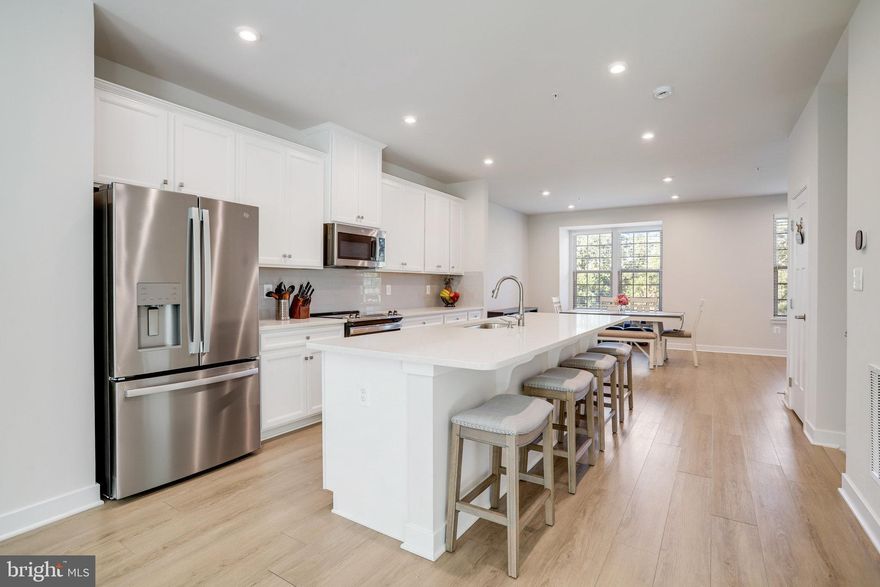 From the moment you arrive, this brick-front townhome commands attention with its classic exterior and modern design. Built in 2023, it offers the best of both worlds: the timeless look of traditional architecture with the conveniences and efficiency of a brand-new home.

The main floor is all about connection and flow, with an open concept design where the dining area blends into a kitchen anchored by sleek finishes that extends to the spacious family room, creating a layout that’s both expansive and practical, complete with generous counter space, ample storage, and a convenient half bath that makes everyday living and entertaining effortless. Just off the family room, a deck adds a refreshing outdoor escape—perfect for a morning coffee or winding down at the end of the day.

Upstairs, three bedrooms offer plenty of space to retreat. The primary suite feels like a sanctuary, complete with a private en suite bath designed with modern finishes that make daily routines feel more like a treat. Two additional bedrooms and a full hall bath mean there’s no shortage of comfort for guests or personal hobbies.

The lower level adds even more flexibility. With its own full bath and rear walkout, it’s ideal for a quiet home office, fitness zone, or the ultimate movie space. Step right outside to the grassy backyard—an open extension of the home that’s perfect for relaxation or simply enjoying a little green space without the upkeep of a large yard.

The home’s updates aren’t just about looks. Because it’s nearly new, big-ticket items like the roof, windows, HVAC, and major systems were all installed in 2023. That means peace of mind now and for years to come. The two-car garage with automatic opener, plus additional driveway parking, makes daily life easy—no circling for a spot when you get home.

Step outside and the advantages keep adding up. This home sits in Westside, a contemporary neighborhood that feels like its own private enclave yet is minutes from everything. Sidewalks and green space thread through the community, and there’s even a playground just a short stroll away. The fenced field and open grassy areas provide room for recreation or simply a little breathing space.

And when convenience matters most, you can’t beat this location. Just beyond the neighborhood, you’ll find a mix of shops, dining, and everyday services that make errands effortless. Major commuter routes—including I-95 and MD-200—are close at hand, putting Baltimore, Washington, and beyond within easy reach.

This isn’t just another townhome. With its nearly new construction, flexible layout, outdoor living spaces, and unbeatable setting in one of Laurel’s most dynamic communities, it’s a chance to claim something special. Forget the others—you’ve just found the game changer.