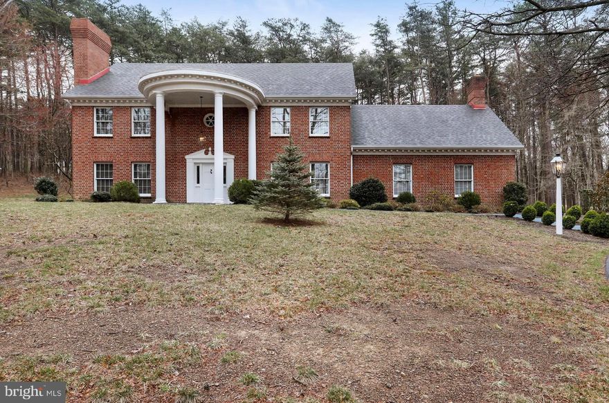 PRICE REDUCED!!! Beautiful High Quality Colonial,  private setting with a wooded corner lot located just outside of Berkeley Springs WV, Paved roads and easy commute to Winchester VA or Martinsburg WV. This one owner home is brick construction, whole / half brick design, brick arches, solid wood turned columns - wood and ceramic floors, granite counters - 4 ft custom curved staircase in the grand foyer - Anderson windows - Full basement with full bath, work area, woodstove - 3 brick chimneys with 8 flues - Closet w/ lights - Large rear deck with vinyl railings - Colligan  water softener - Brick walkways and professionally landscaped -Bonus room above the garage just waitng to be finnished.Truly a must see home.