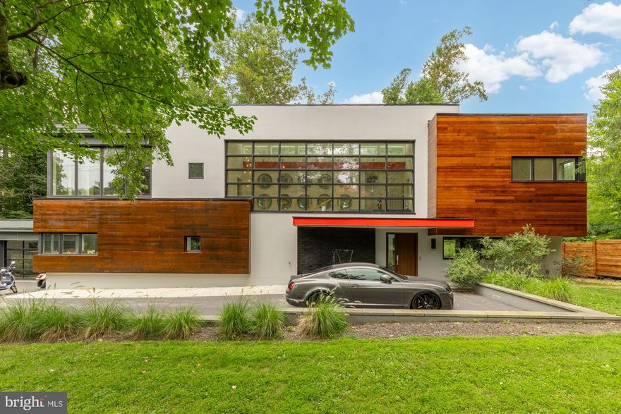 Striking modern architecture and refined luxury come together in this exceptional contemporary residence, set on over ONE ACRE of rare, private land just moments from downtown Bethesda, an extraordinarily hard-to-find combination of scale, privacy, and proximity.

Defined by clean lines, expansive windows, and warm architectural materials, the home blends modern design with its natural surroundings, creating a private retreat that feels both sophisticated and serene. Recently reimagined with a thoughtfully updated layout and beautifully renovated baths, the residence spans over 5,400 square feet of light-filled living space designed for effortless everyday living and elevated entertaining.

Inside, the home showcases rich hardwood flooring throughout the upper level and sleek modern tile on the main level, reinforcing a thoughtful balance of warmth and contemporary style. Soaring ceilings and oversized windows bring in abundant natural light while maintaining privacy throughout. Designer finishes, motorized shades, and a Savant smart-home system further enhance the home’s modern functionality without sacrificing comfort.

The gourmet kitchen anchors the main living level, offering generous prep space, high-end finishes, and exceptional pantry and storage capacity, an uncommon luxury in modern homes. Open living and dining areas flow seamlessly to the outdoors, creating an entertainer’s layout equally suited for intimate evenings or large-scale gatherings.

The upper level features four spacious bedrooms and four beautifully updated full baths, including a luxurious primary suite designed as a true private retreat. The primary suite opens to a private balcony and features a spa-inspired bath with a soaking tub, zero-threshold (curbless) shower, double vanities, a private water closet, and thoughtfully designed architectural and ambient lighting that elevates the experience from day to night.

The main level includes an additional bedroom and full bath, ideal for guests, an office suite, or flexible living arrangements.

Outdoors, the property unfolds into a true resort-style sanctuary. A sprawling patio, lush privacy, and a stunning pool with an electronic cover create an outdoor oasis rarely found so close to downtown Bethesda. Whether hosting poolside gatherings, enjoying quiet mornings surrounded by nature, or unwinding at the end of the day, the setting offers a level of space and tranquility that is nearly impossible to replicate.

Additional highlights include a garage with a striking glass-panel door, abundant storage throughout, and a location that delivers the best of both worlds: over an acre of land with immediate access to Bethesda Row, dining, shopping, and Metro.

Why go to a hotel when you can go home!  PRIVATE RESIDENCE  - BY APPOINTMENT ONLY