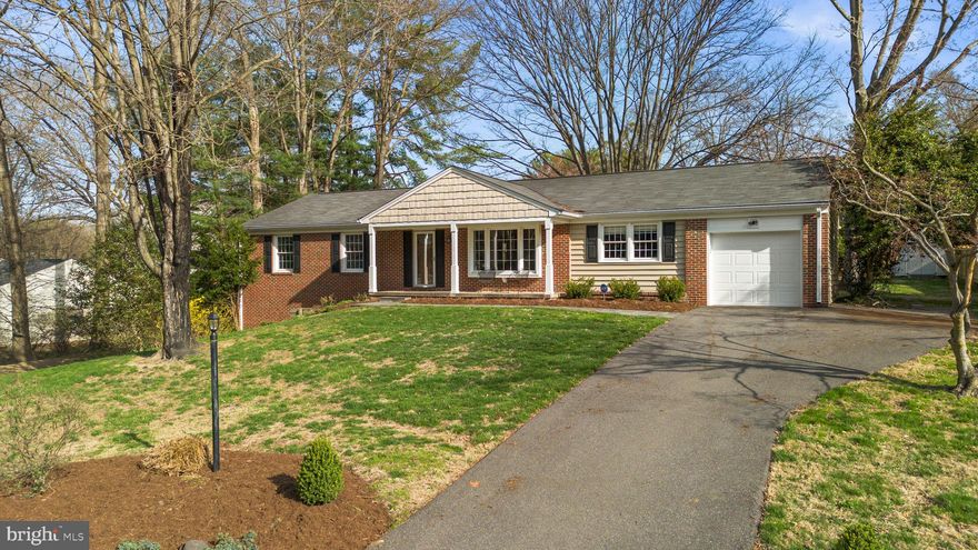 Charming and well-maintained ranch-style residence offering 4 bedrooms, 2 bathrooms, 2,469 finished square feet, and a 1-car garage in desirable Dunloggin. A welcoming front porch leads into a traditional foyer accented by vibrant slate flooring, opening to a spacious formal living room filled with natural light from a bay window. Hardwood floors flow seamlessly throughout the main level, continuing into a generously sized family room with both garage access (garage doors replaced in 2014) and exterior access for added convenience.  The thoughtfully updated eat-in kitchen, renovated in 2012, features stainless steel appliances, including double ovens, upgraded granite countertops, pendant lighting, and ample rich cabinetry with a mix of open shelving. A breakfast bar connects the kitchen to the formal dining room, creating a seamless layout ideal for everyday living and entertaining. Hardwood flooring extends into three main-level bedrooms, including the primary suite with a fully renovated en suite bath completed in 2011, while a second full bathroom was updated in 2014.  The bright, walk-out lower level offers exceptional additional living space, featuring a large recreation room with LVT flooring and built-ins, a fourth bedroom with plush carpeting, a versatile bonus room ideal for a home office, a spacious storage area, and a utility room with laundry facilities. Outdoor living is equally inviting with an open-air deck overlooking a large, open backyard, complemented by a lower patio and a detached storage shed.