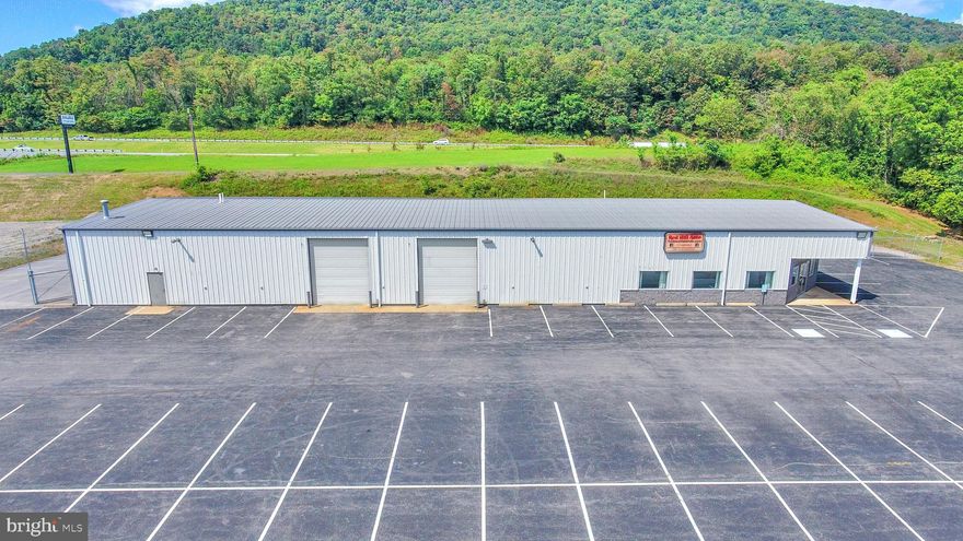 One of a kind 9,600 Sq. Ft commercial building sitting on 7.05 acres with high visibility from 22/322W. This property was most recently used as a car dealership but affords many possibilities for usage. Property features  six (6)  14' overhead doors, 18 Ft. ceilings, over 100 parking spots, a full bath & breakroom, and a showroom with several offices. Don't miss your chance to own this stunner!