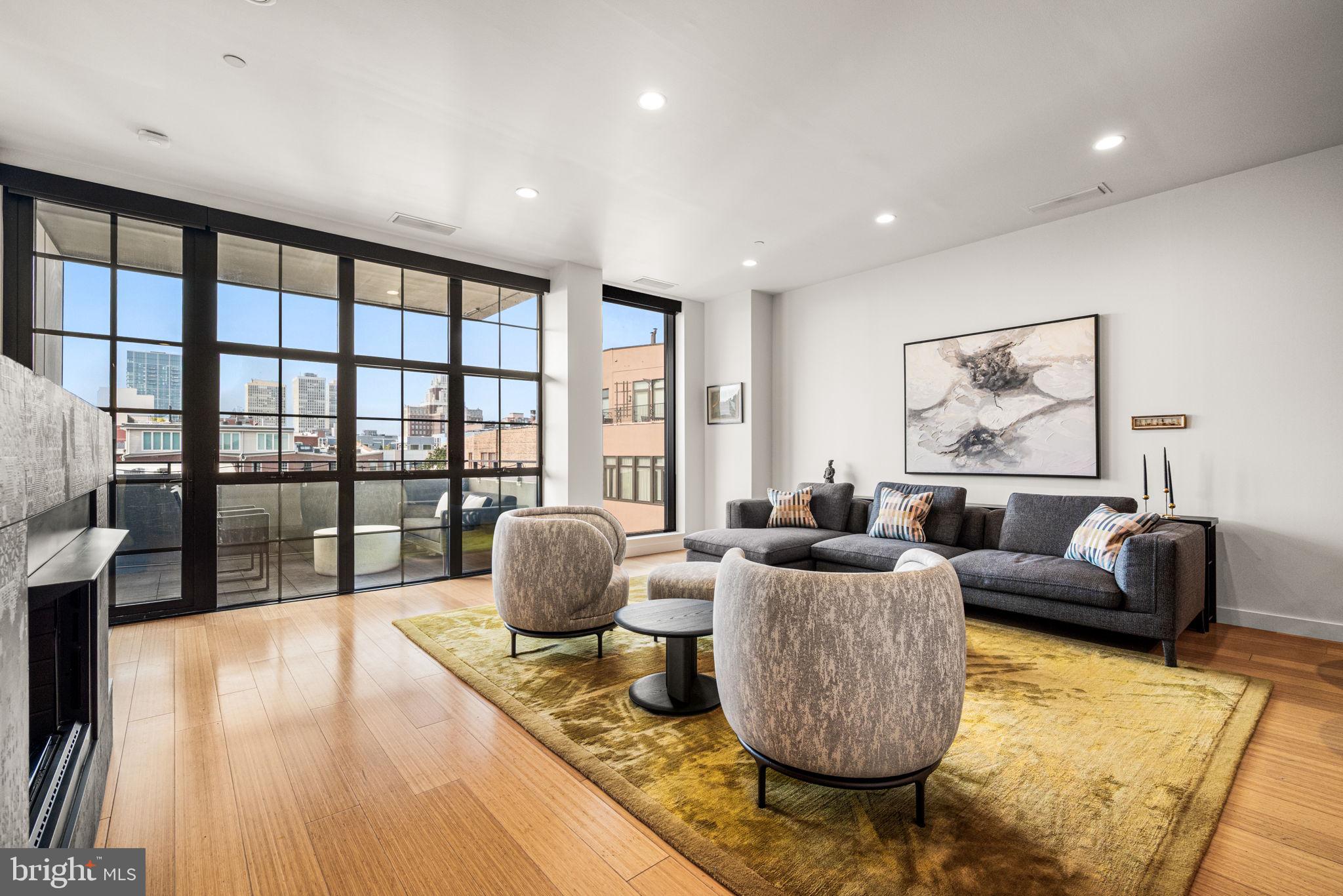 Welcome to 108 Arch Street #504, a stunning two-bedroom, two-bathroom condominium offering luxury living in one of Philadelphia’s premier boutique buildings in the heart of Old City. This impressive home boasts high-quality custom finishes, outdoor living space and on-site gated PARKING. Enter through the concierge-staffed lobby, or the secure parking area, and ride one of two high-speed elevators to your private wing—shared with only one other unit. Your front door is conveniently located just steps from the elevator. Step inside and you’ll immediately notice the modern bamboo floors and luxurious design elements bringing warmth and sophistication to this elevated living space. The expansive main living area is flooded with natural light from floor-to-ceiling windows complete with custom motorized solar shades and soaring 10-foot ceilings. A striking gas fireplace serves as the centerpiece of the room, seamlessly integrated into a contemporary built-in wall unit featuring matte black textured tile and a sleek panel that discreetly hides electronics. The chef’s kitchen is equipped with professional-grade appliances (Viking gas range, Fisher & Paykel dual-drawer dishwasher, and Sub-Zero refrigerator), a peninsula island with bar seating and a large pantry. From the living room, step out onto your private terrace, where you can enjoy breathtaking views of Old City. The spacious primary bedroom offers a walk-in closet, blackout curtains and motorized shades, plus a completely remodeled en-suite bath featuring a floating vanity and a frameless walk-in shower with terrazzo tile. A second bedroom, currently serving as a sitting room, is tucked away on the opposite side of the home for optimal privacy. The beautifully remodeled guest bathroom features intricate mosaic tile, a floating wood vanity and a walk-in shower. A dedicated laundry/utility room completes the thoughtful layout. This pet-friendly residence is just a short walk to historic landmarks such as Independence Hall and Elfreth’s Alley, as well as amazing art galleries, boutiques, coffee shops and restaurants. Schedule your showing today!