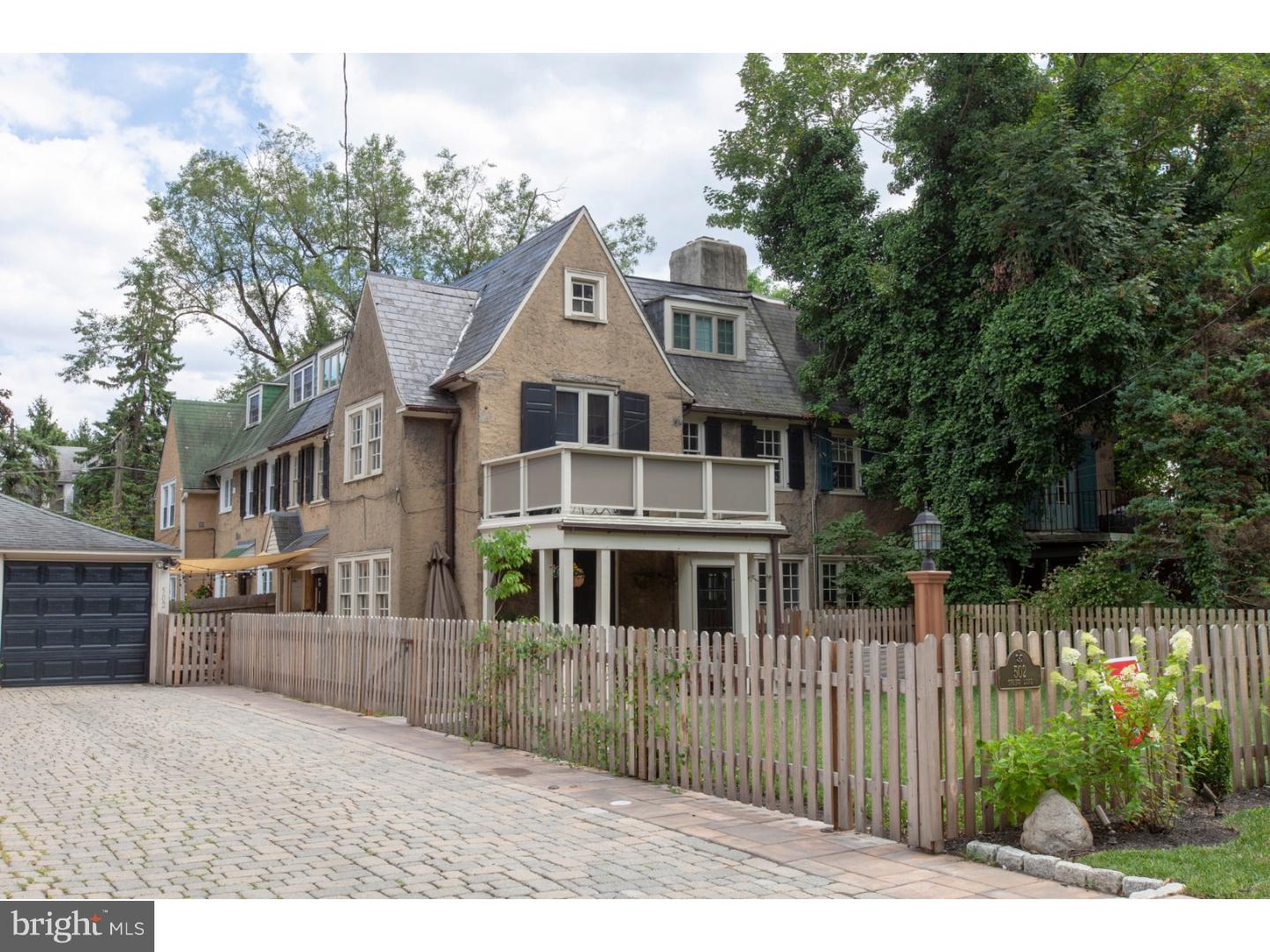 Welcome home to this 4 BR/2.5 BA 1920's English cottage twin in the desirable Springfield Township School District just over the Chestnut Hill border. This unique home has been lovingly cared for and recently updated. Enter through the front vestibule to the living room. Spacious and light filled with hardwood flooring and a beautiful wood burning stone fireplace, this room is perfect for every day living. Make your way into the sun filled dining room with French doors leading to the front patio, perfect for entertaining! The dining room opens to the thoughtfully renovated kitchen with stainless steel appliances, custom hood with reclaimed wood, quartzite counter tops, built-in bench seating with storage, and even a coffee bar! The covered patio off the kitchen truly gives you the feeling that you're living in an English village. Ascend to the second level where you'll find a large office with built-in desk and shelves which can easily double as guest quarters. Enter the spacious light filled master suite to find vaulted ceilings, French doors to a private deck overlooking the perfect sized fenced-in manicured lawn, a large dressing room and the en-suite bath. The third floor boasts two additional bedrooms and hall bath with stunning claw foot tub. The lower level is perfect for additional living space and has plenty of room for storage plus a convenient powder room! Outside the house has a 1 car detached garage and parking for 2-3 cars. Recently updates include new AC condenser, new landscaping, patio & pavers, exterior lighting, kitchen & appliances, basement remodeled with coretec flooring, tankless hot water heater, new windows on 3rd floor. Close to public transportation including Gravers Lane train station, playground/dog park and a short walk to the shops, restaurants and cafes on Germantown Avenue.  Easy access to Center City, the suburbs and major highways.