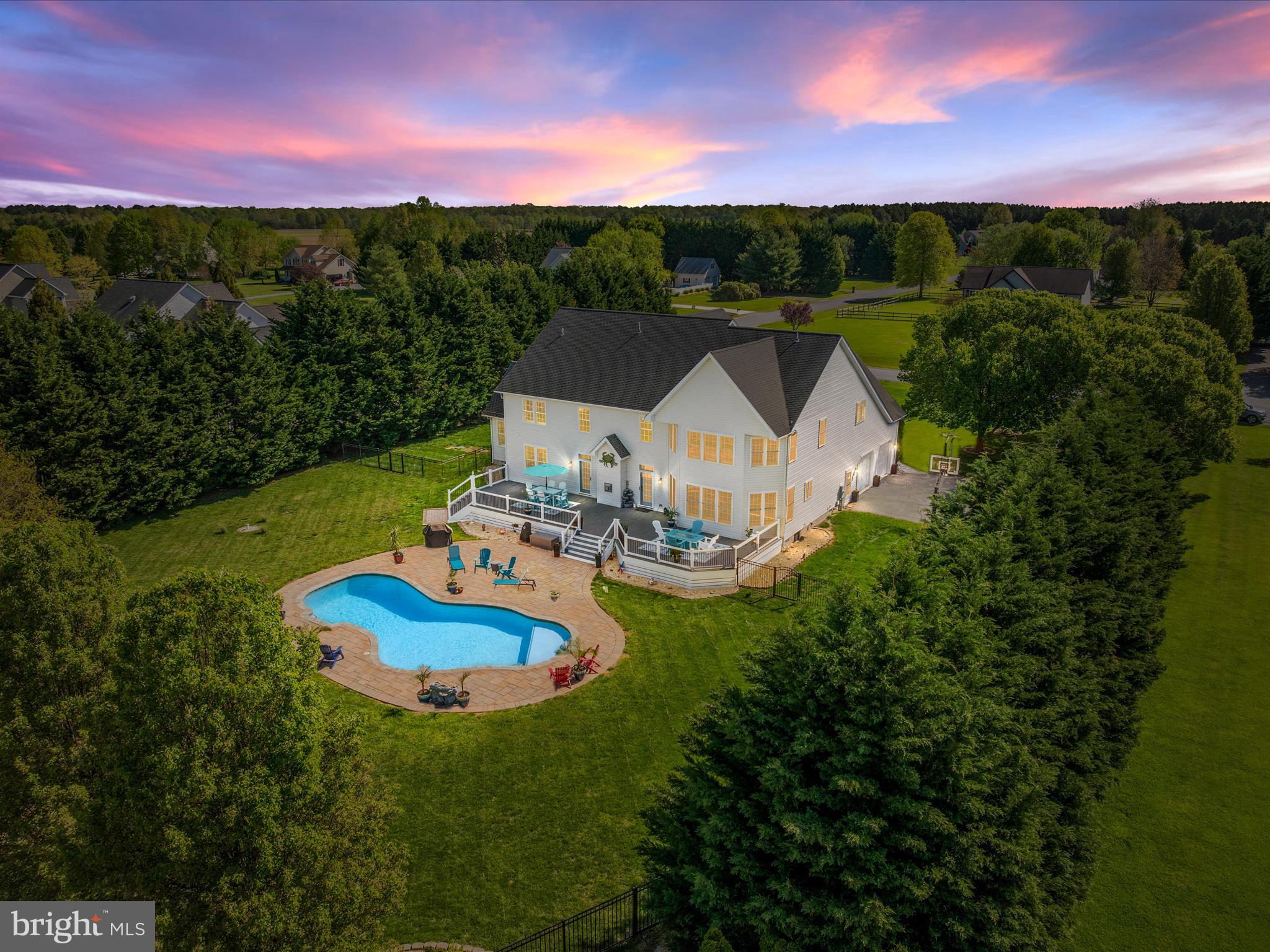 HOT NEW PRICE! Come BEAT THE HEAT and DIVE INTO YOUR VERY OWN PRIVATE POOL!! Incredible deal for this Million Dollar Home! Welcome to this stunning Colonial in the sought-after Claiborne Fields Community and get ready to be WOWED! Built in 2002 and meticulously maintained, this Elegant 2-story Home sits on a private 1 Acre lot and offers over 4,900 square feet of beautifully finished living space. With 4 spacious Bedrooms, 2.5 Bathrooms, a sparkling Saltwater Pool, and an oversized 2-car garage with ample storage, this property combines luxury, comfort, and functionality in one Exceptional Package! No detail has been overlooked, with almost $400K in high-end Upgrades- all completed within the past few years. The NEW "Chef Inspired" Gourmet Kitchen is a standout, featuring a 6-burner gas stove, wall oven, built-in microwave that doubles as a convection oven, granite countertops, an expansive island and massive Butler's Pantry! Soft close upgraded cabinets, a stylish glass tile backsplash, a farm sink and ambient cabinet lighting add warmth and sophistication to this must have Kitchen! Step into the grand 2-story foyer with its sweeping staircase and immediately feel the sense of scale and elegance. The heart of the home is the stunning great room, anchored by a dramatic 2-story stone gas fireplace that radiates warmth and charm. The main level also boasts formal living and dining rooms, a home office, beautiful built-ins, decorative crown molding, chair rail, and wainscoting. A large mudroom, laundry room and a bonus den/game room with a pool table offer added flexibility for everyday living and entertaining! Upstairs, the luxurious primary suite is your private retreat, complete with cathedral ceilings, a sitting area and a spa-like en-suite bath! Enjoy the massive walk-in closet and two additional walk-in closets for maximum storage. Three additional bedrooms share an updated full bath providing plenty of space for family and guests. Outdoor living is just as impressive! A newly built Composite Deck with LED Lighting overlooks the saltwater pool which is surrounded by elegant paver stones and aluminum fencing. Whether you’re relaxing with a drink while watching the Sunset, hosting gatherings or shooting hoops under the night-lit basketball goal, this property is made for making memories! Additional updates include plantation shutters, new flooring in kitchen and bathrooms, custom interior paint, wireless smoke detectors integrated into the alarm system, hardscaping, a reverse osmosis water filtration system, tankless hot water heater, HVAC, a new pool pump, encapsulated crawlspace... and the list goes on! Located just 30 minutes to the Chesapeake Bay Bridge and a quick trip to DE, this home offers the perfect blend of tranquil, rural living with easy access to shopping, dining, parks, sports fields, schools, library, trails and water recreation! Come enjoy Eastern Shore Living! *Be sure to check out the extensive list of upgrades attached*