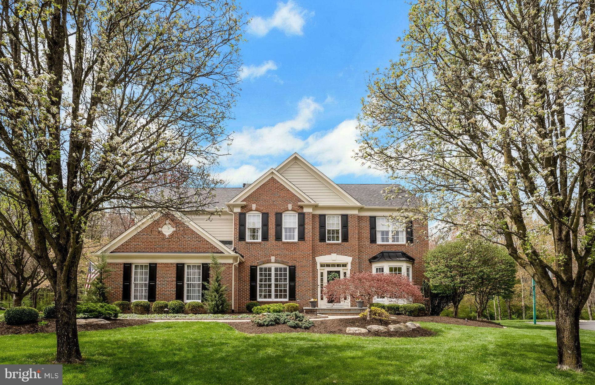 Perfectly positioned on one of the most premier lots in the sought-after Chestnut Creek development, this stunning brick-front colonial offers a rare blend of timeless charm and modern comfort. Backing to serene woods and surrounded by lush, mature landscaping, this home promises privacy, peace, and picturesque views in every direction. From the moment you arrive, you’re greeted by a beautiful walkway leading to a meticulously maintained façade. Step inside to a sunlit two-story foyer with gleaming hardwood floors that flow throughout most of the main level. The gracious staircase sets a classic tone and is flanked by two elegant spaces: a private home office with French doors, rich millwork, and a bay window with a great view—perfect for remote work—and a formal dining room adorned with exquisite dental crown molding and wainscoting, ideal for holidays and entertaining. The formal living room offers a triple window that frames scenic backyard views, inviting relaxation and conversation. The spacious family room is the heart of the home, featuring a cozy fireplace, soaring ceilings, and floor-to-ceiling windows that flood the space with natural light. This open-concept room flows seamlessly into the kitchen and morning room, creating the perfect layout for modern living and effortless entertaining. The updated kitchen is a culinary masterpiece with white cabinetry, custom ceiling molding, granite countertops, subway tile backsplash, and a large island with seating and pendant lighting. Additional features include a bar/coffee station with wine fridge, pantry closet, stainless steel appliances including a 5-burner gas cooktop, double oven, an oversized sink and a breakfast bar with counter seating. The adjacent morning room, surrounded by windows on two sides, opens to an expansive deck—a perfect spot to enjoy daily dining , sip coffee or enjoy a meal with nature as your backdrop. A well-appointed mud/laundry room with garage access adds everyday convenience, while a tasteful powder room completes the first floor. Upstairs, find four generously sized bedrooms, all with ceiling fans and ample closet space. Two bedrooms offer double closets, and a third features a walk-in closet with plumbing nearby (and detailed plans), perfect for a future en-suite bath. The primary suite is a true retreat, featuring a tray ceiling, a wall of windows with gorgeous, wooded views, and a luxurious spa-like bath with marble tile, double sinks, a soaking tub, and an oversized stall shower with a bench seat. The walk-in closet includes a custom system and a laundry chute for added ease. The finished basement is ideal for hosting parties or game nights and includes a bar area with sink and bar fridge, exercise area, and an expansive storage/workshop space. Step outside to a massive deck with a retractable awning and dual staircases leading to the yard. A retaining wall with beautiful plantings, mature trees, and open grassy areas make this backyard perfect for entertaining, playing ball, or relaxing under the stars. An irrigation system helps keep the grass and plantings looking good! Roof/Systems updates include new roof (2023) Newer HVAC (2020) Hot water heater (2022). Located just minutes from the PA Turnpike, top-rated schools, township parks, shopping, dining, and the local library, this home combines luxury, location, and lifestyle in one amazing package. Don’t Miss This Opportunity—Schedule Your Private Tour Today!