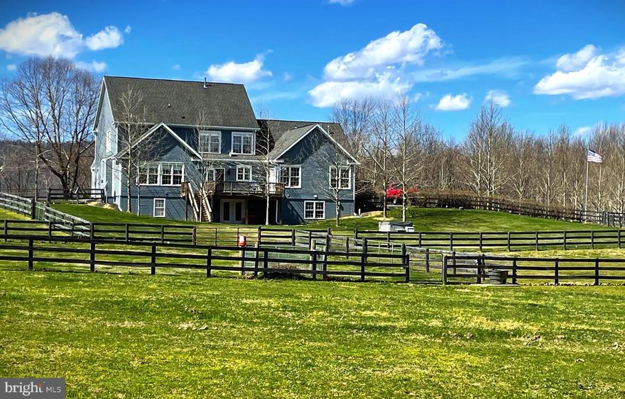 Great time to buy as all inspections have been recently completed.  Rare opportunity to purchase an amazingly well appointed property in Western Loudoun County.  This beautiful modern farmhouse privately sited at the center of over 20 unrestricted acres with mountain views is surrounded by bridle paths and paddocks. The 7,200+ square foot residence is located at the high point on the farm at the top of a tree-lined paved drive where the entire property can be watched. 
The home boasts a main level owner's suite, 3 additional bedrooms upstairs, generously sized rooms throughout, and a massive walkout unfinished basement with full bath and plenty of space to use as you please. The covered front porch offers a great spot for viewing the mountains and sunsets, while the covered deck is the perfect spot to enjoy the morning coffee as the sun greets you.   When the work day's been too strong, just hop on into the hot tub and gaze up at the stars.  Out here you can really see them well.  Heck you might even decide to add a swimming pool, and there's a perfect spot for it right next to the  hot tub.
All of the paddocks have electric and water, and are gated for easy transfer between fields or to the 50x100 barn. There's also an additional well and the option to subdivide or build an additional dwelling. This home has no HOA or restrictive covenants.