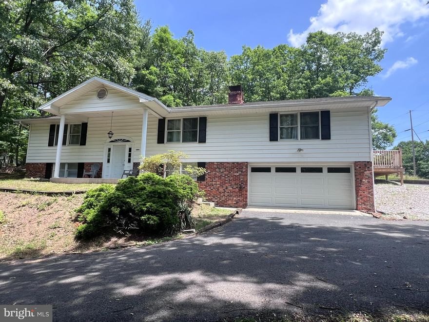 Newly renovated in 2022, appraised in 2023 and is listed under the appraised valuel!  Split level home on 1.78 unrestricted acres, nestled in a quiet community with the privacy of trees and wooded area. Just minutes from downtown Berkeley Springs and Valley Health's War Memorial Hospital.  Enter the foyer up the stairs to the main floor.  The main floor offers 2 bedrooms and 1.5 baths.  The newly renovated kitchen has Quartz countertops, stainless steel appliances, a pantry, breakfast area, and a flat, self cleaning oven. Enjoy the open concept living room and dining room for hosting family and friend gatherings . Sit out on the new deck watching wildlife.  Get cozy in the family room with an electric fireplace that has an option to produce heat.  The lower level consists of 2 bedrooms, 1 full bath, laundry area and utility rooms with storage space.  This home has lots of closets and large rooms.  Plumbing, electric, HVAC, LPV floors, carpet and all appliances were upgraded at the time of renovation. The long driveway that continues to wrap around the back of the home provides plenty of parking for large families or gatherings.  This home is close to main roads and access to the new By-Pass for commuting to surrounding areas.