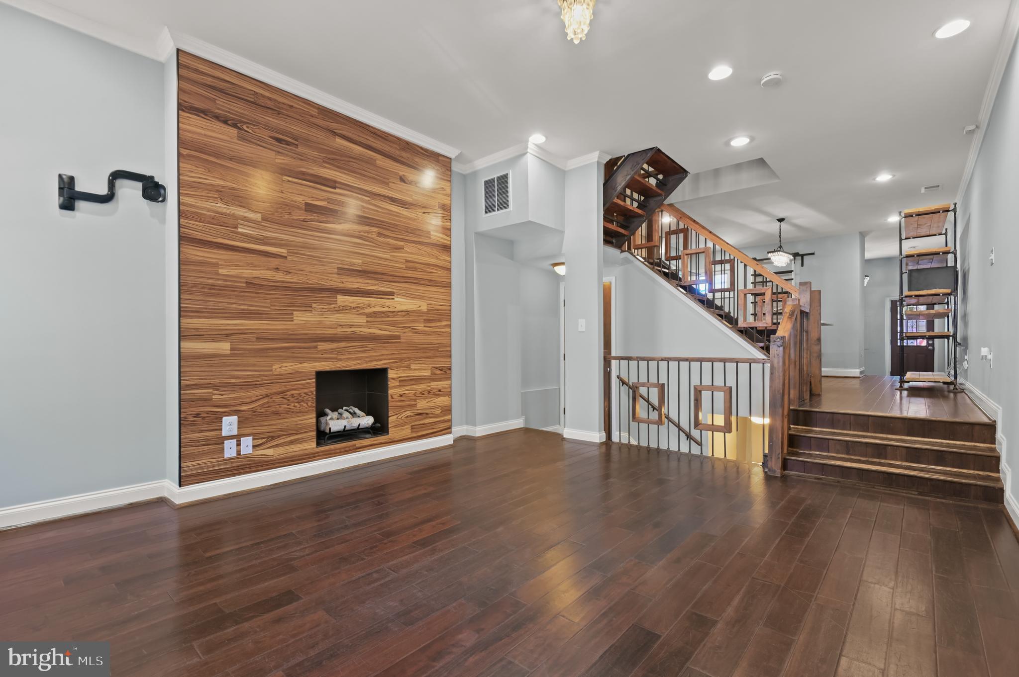 Escape the city bustle in this Urban Retreat in Station North Art District is this Brimming home with over 2,000 sf of warm livability. This vintage industrial renovation features environmentally-sensitive fireplaces, a recycled wood/iron staircase, Carrara marble counters & many custom features. Gorgeous and eco-friendly with your own private backyard and in a fantastic location next to a park! Walk to Penn Station, University of Baltimore Law School, and MICA. Schedule your tour today!