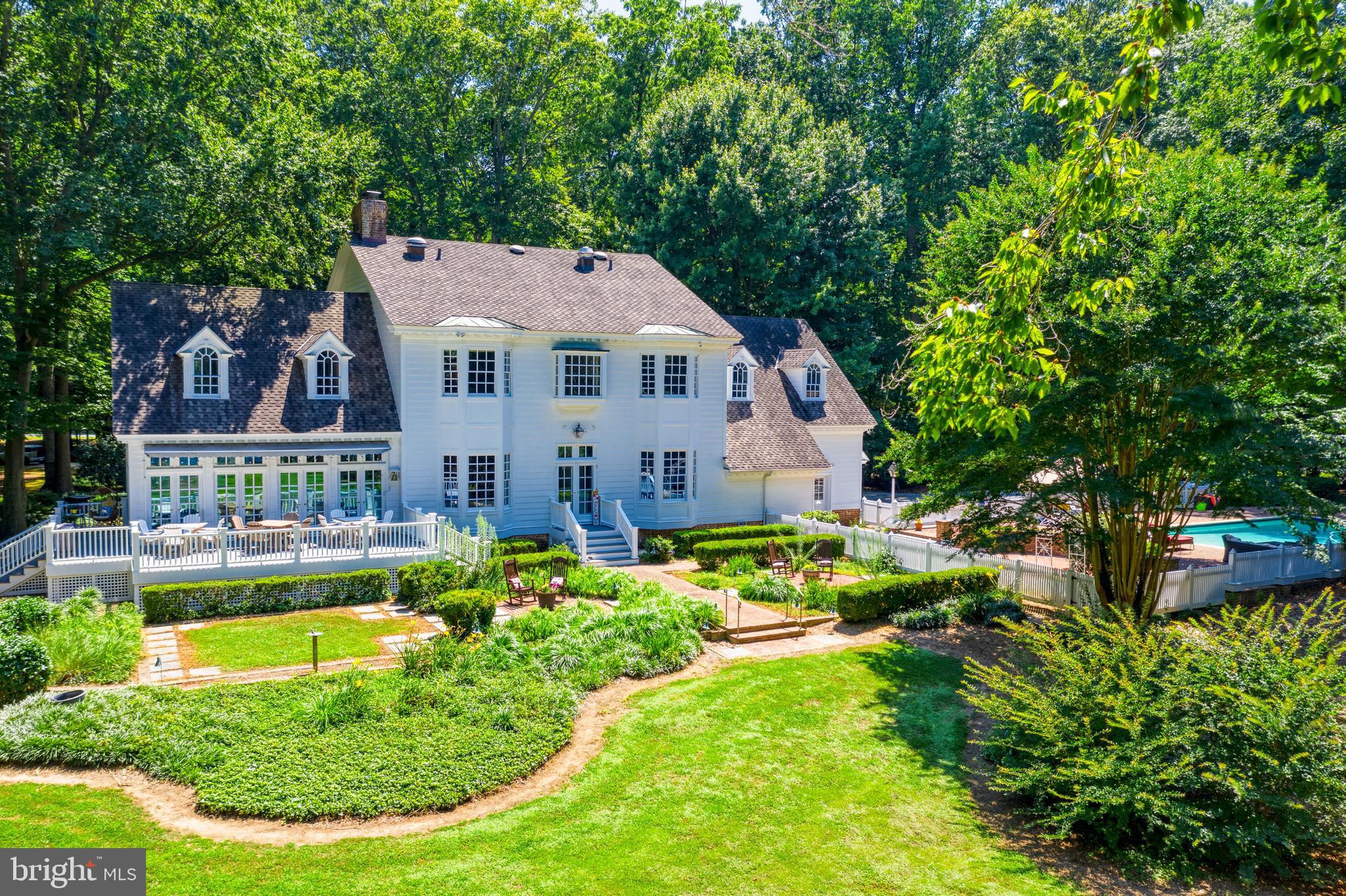 Paddle your own canoe across tranquil waters of the Wye River, walk your dog on the 5.2 acres set amidst flowering shrubs and colorful plantings and view magnificent sunsets from your in-ground pool and spa or dock. This 6,159-square-foot, 4 bedroom, 5 ½ bath New England Waterfront offers the ultimate in fine living. You’ll love the 47x8 central hallway with custom arches at each end, intricate mouldings, high ceilings, gourmet kitchen, royal-size master suite with separate his-and-hers dressing room, private home office, gleaming hardwood floors, two fireplaces, private pier with 2 boat lifts 5' MLW, geothermal heating & air, full unfinished basement and oversized 2-car garage to hold all the toys. Abundant space for hosting baby/bridal showers and holiday dinners with ease in the large, sun-drenched sunroom. Unexcelled for weekends or weeks on end.