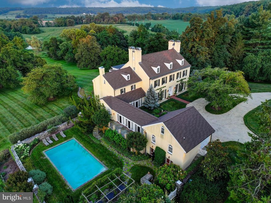 Live authentically. Montmorenci | Circa 1741. Built by Samuel Worthington. Commanding views overlooking Worthington Valley, Montmorenci is a storied estate steeped in history. Revel in the sense of arrival as you meander the tree-lined drive. The welcoming crunch of gravel in the roundabout as you step to enter.  A grand living hall whets your appetite for what's to come. Feel the difference that balanced proportions and the layering of a timeless European aesthetic can make in your daily life. Original details intact. Exceptional handcrafted millwork lends grace and depth to generous, light-filled rooms designed for living and gathering. Relish the farm to table healthy lifestyle... vegetables and herbs teaming with flavor picked directly from your garden. The chef’s kitchen invites connection, anchored by a fireplace and glorious views of the pond in the distance. Entertain effortlessly. Experience functionality and flow that has been meticulously designed for gatherings both intimate and large.  A handsomely appointed library awaits your collected volumes and curiosities. A significant architectural, sculpted mahogany staircase rises with grace. The primary suite, sumptuous and rich in detail, opens to an expansive terrace with sweeping views, while the spa-like bath offers fireside soaks and a moment to exhale. Separate primary suite baths, each with it's own distinctive personality and vista. Each secondary suite exudes exemplary style and unique character. 
Flow through the multi-purpose loggia to the sweeping gardens and curated grounds, where nature delights at every turn. Glass doors reveal landscaped terraces, verdant gardens, and the serene rhythm of nature. Lounge poolside and imbibe beneath the cross vine covered pergola, take in the clear skies and stars above as the evening settles in. Invigorate with sunrise laps. Charming pool-house tucked beneath the loggia. 
A fabulous brick barn, substantial stone tenant house, two apartments, a repurposed corn crib, and three pristine paddocks—cultivating a distinguished country lifestyle rooted in heritage. Comcast Internet. Cultivate your existence. The art of uniting human and home.