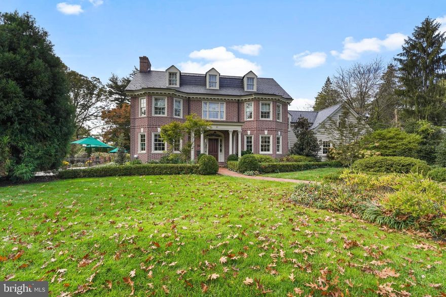 This property includes the Grand Main House and a Charming Cottage--presenting the perfect opportunity for extended family, long term guests, or au pair quarters--whatever best suits your needs. Offering the refined charm of an estate home built in 1939, the current owners extensively remodeled and updated both the interior and exterior of the Main House (including a slate roof) in 2003-2004 before taking residence.  The finishes were tastefully enhanced and the house was also made substantially larger with an addition that provided space to add a fabulous open concept Family Room and Kitchen, expansion of the Formal Dining Room, and room for a spacious Primary Bedroom and luxurious Primary Bath.  Any discerning buyer will marvel at the skill of the artisans who created the exquisite paneling and intricate 
ceiling design in the Living Room, Entryway and Dining Room.  The sumptuous Family Room with fireplace and coffered ceiling, Informal Eating Area and exquisite gourmet Kitchen are indications of the desire of the current owners to make living in this home a genuine pleasure.  In addition to the spacious Primary Suite there are 3 Bedrooms, each with its own character and delightful features such as arched windows, 
eyebrow windows, built-ins, and impressive tree top views that provide a sense of peace and tranquility.  There is also an exceptional Office with a private Half Bath.  The Office could be used as a quiet retreat or be easily utilized as a Fifth Bedroom. Even the Laundry Room is a space that is so inviting you will actually enjoy being there!  The Lower Level provides an unexpected delight with a Second Family Room (perhaps you desire an amazing man cave?) with radiant heated floors, powder room, gas fireplace, and a substantial lounging area where you can enjoy your favorite sports, movies, or your next Netflix binge!  There is a large wet bar that is well outfitted with a kegerator, dishwasher, microwave and two cooling drawers. Another feature is a Wine Cellar, the perfect place to store and display your favorite vintages.  In addition, the Main House has a 2 Car Attached Garage.
When you want to get a breath of fresh air, the gardens will welcome you and offer beauty and serenity.  Just off the spacious slate patio, you'll discover trellised covered steps which lead to the recessed garden where gravel paths beckon you to admire nature's artistry and a handsome fountain in a setting that is ideal for picturesque statuary. The other end of this breathtaking outdoor expanse leads you to a path where you will encounter the most charming Cottage you will ever hope to find!  The large Great Room with beamed ceiling features a huge fireplace with gas logs, paneling and gorgeous wide plank pine flooring.  For convenience, there is a Powder Room on the first floor as well. The Cottage has been updated with a Kitchen renovation and the installation of central air conditioning. Upstairs you will find Three Bedrooms and a Full Bathroom. The Cottage also enjoys a fenced yard and a detached 2 Car Oversized Garage with pull down steps to added storage space.  
This gated estate enjoys complete privacy yet it’s conveniently located--just steps to the bustling and desirable town of Media.  Leave the car at home when you feel like Dining Under the Stars on Wednesday evening in town, as you savor your favorite beverage and cuisine.  Center City Philadelphia, Philly International Airport, and trains are all conveniently located making Bent Road an absolute treasure in an ideal locale!