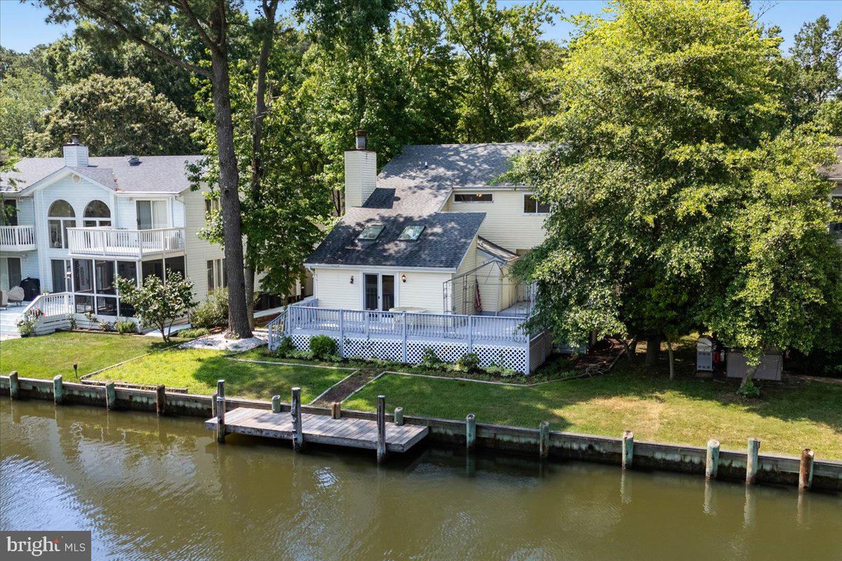 20K PRICE REDUCTION!!!
An unparalleled waterfront oasis in a vibrant coastal community. Enjoy 60 feet of bulkhead waterfront with a well-maintained lateral dock, offering easy access for boating and kayaking . Thoughtfully designed floor plan with TWO spacious primary suites, one on the main level with direct water views and one on the second floor, each with their own full bathrooms. Plus two additional bedrooms upstairs with a large full bathroom to share. One half bathroom serves as powder room on the lower level . An updated kitchen that features new cabinets, luxury vinyl plank flooring, and all-electric stainless steel appliances, including double oven, built-in microwave, ice/water-refrigerator — perfectly suited for entertaining. Open living/dining area anchored by an electric fireplace, complemented by a second fireplace in the main-level suite. New HVAC (2021). Wraparound deck with new railings. Dock replaced in 2024. So much potential to make it yours! With its functional layout and ample outdoor spaces, it’s an ideal home for family living or resort-style leisure. Don’t miss this rare opportunity — schedule your showing today and start imagining life on the water.